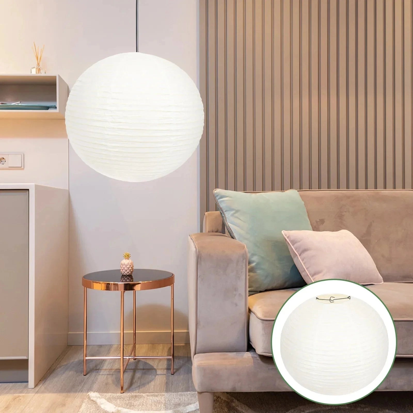 Large white paper pendant light hanging in a minimalist Scandinavian styled room, featuring a wooden table and chairs, with dishware set on the table. The setting emphasizes comfort and interior design aesthetics.