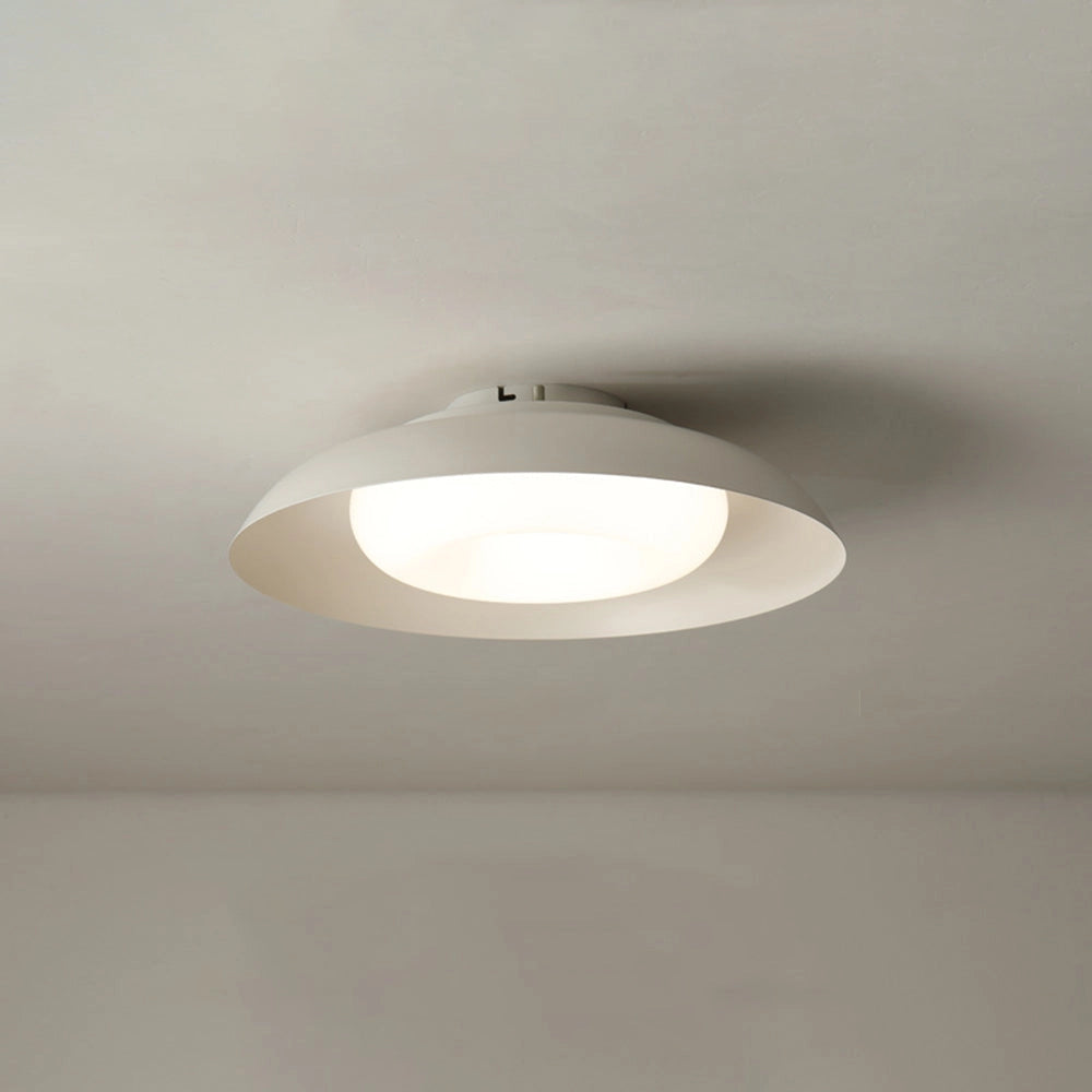 Modern minimalist round LED ceiling light with a soft-white glow, flush-mounted on a ceiling.