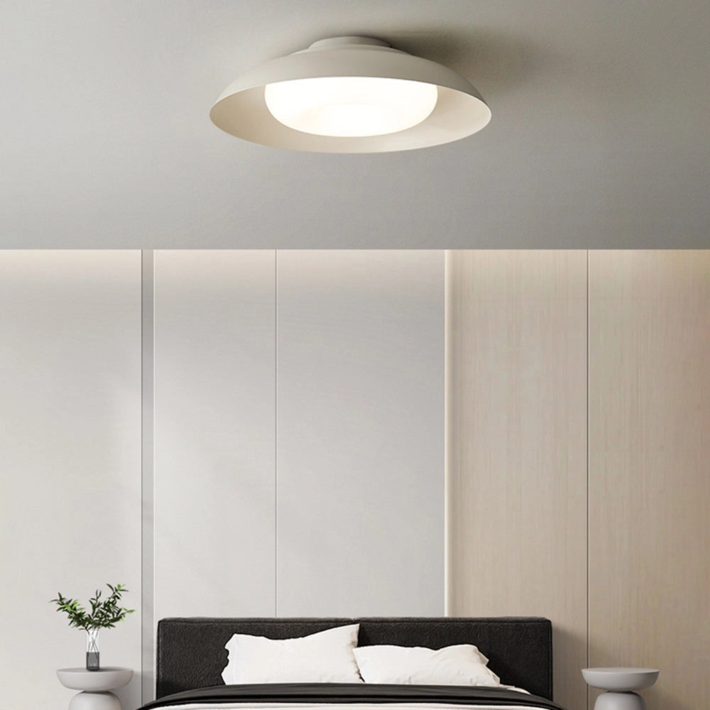 Modern minimalist round LED ceiling light in soft-white, flush-mounted style, illuminating a sleek interior space with contemporary design elements.