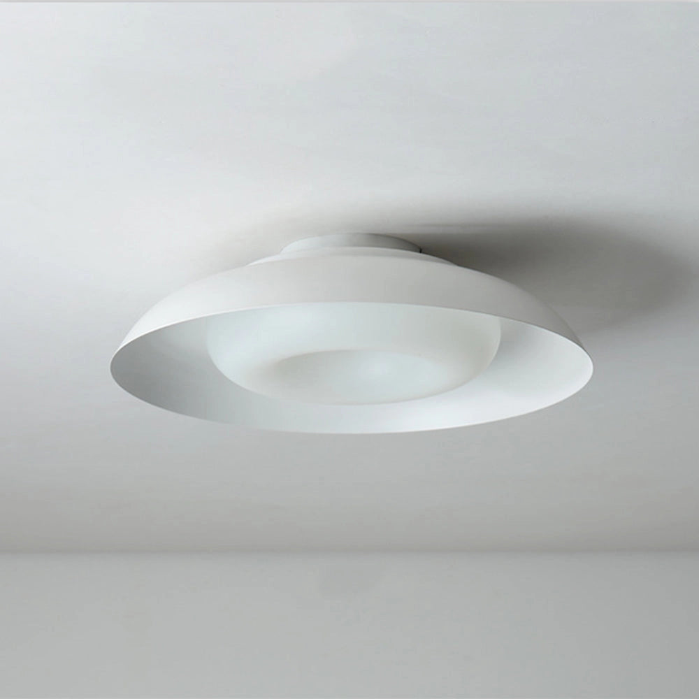 Modern minimalist round LED ceiling light with a soft-white glow, flush-mounted onto a ceiling, featuring a sleek circular design and a transparent material finish.