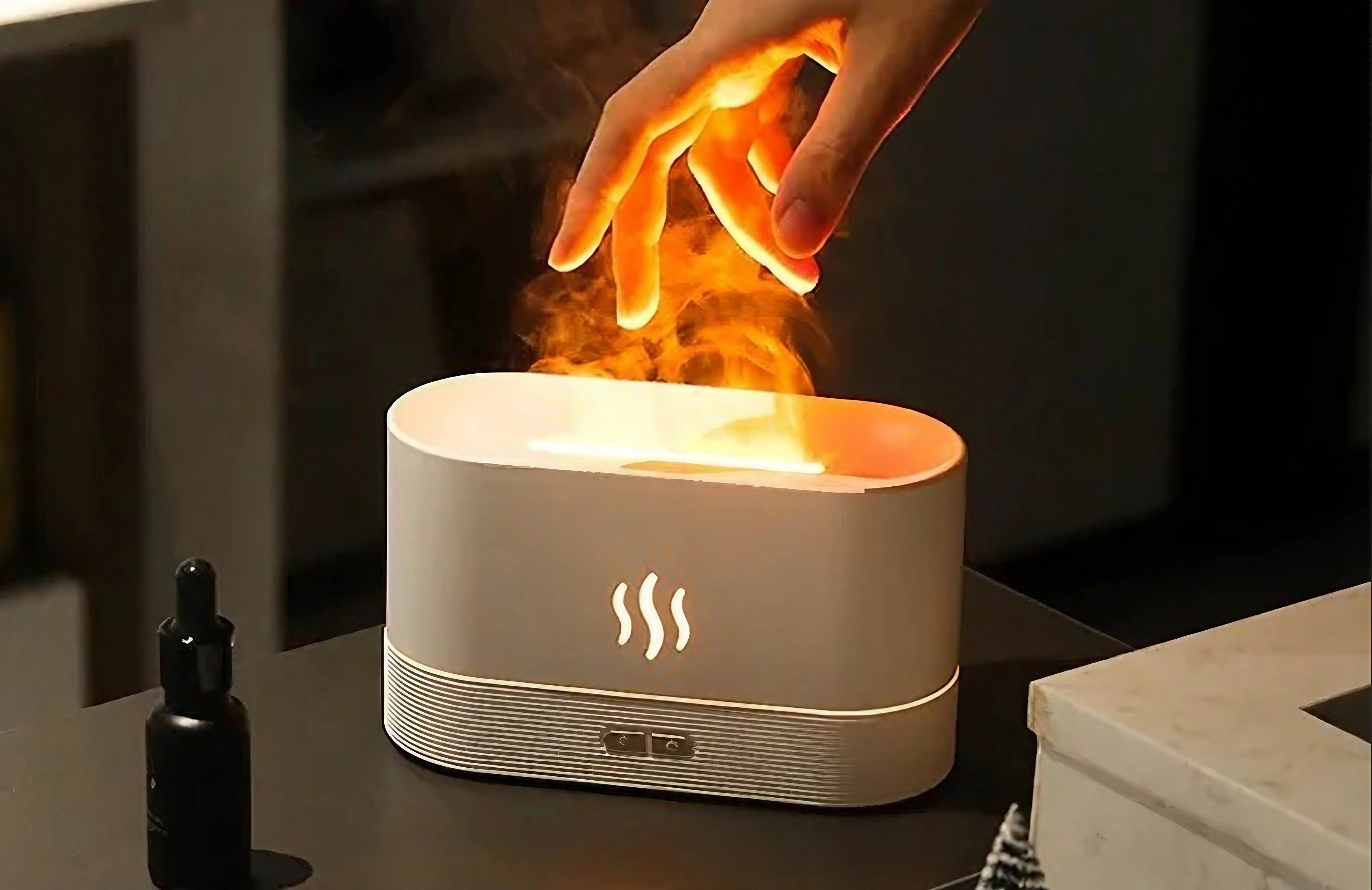 A white LED flame aroma diffuser and ultrasonic mist maker humidifier, designed to resemble a flickering flame with a soft glow, ideal for creating a calming ambiance in any room.