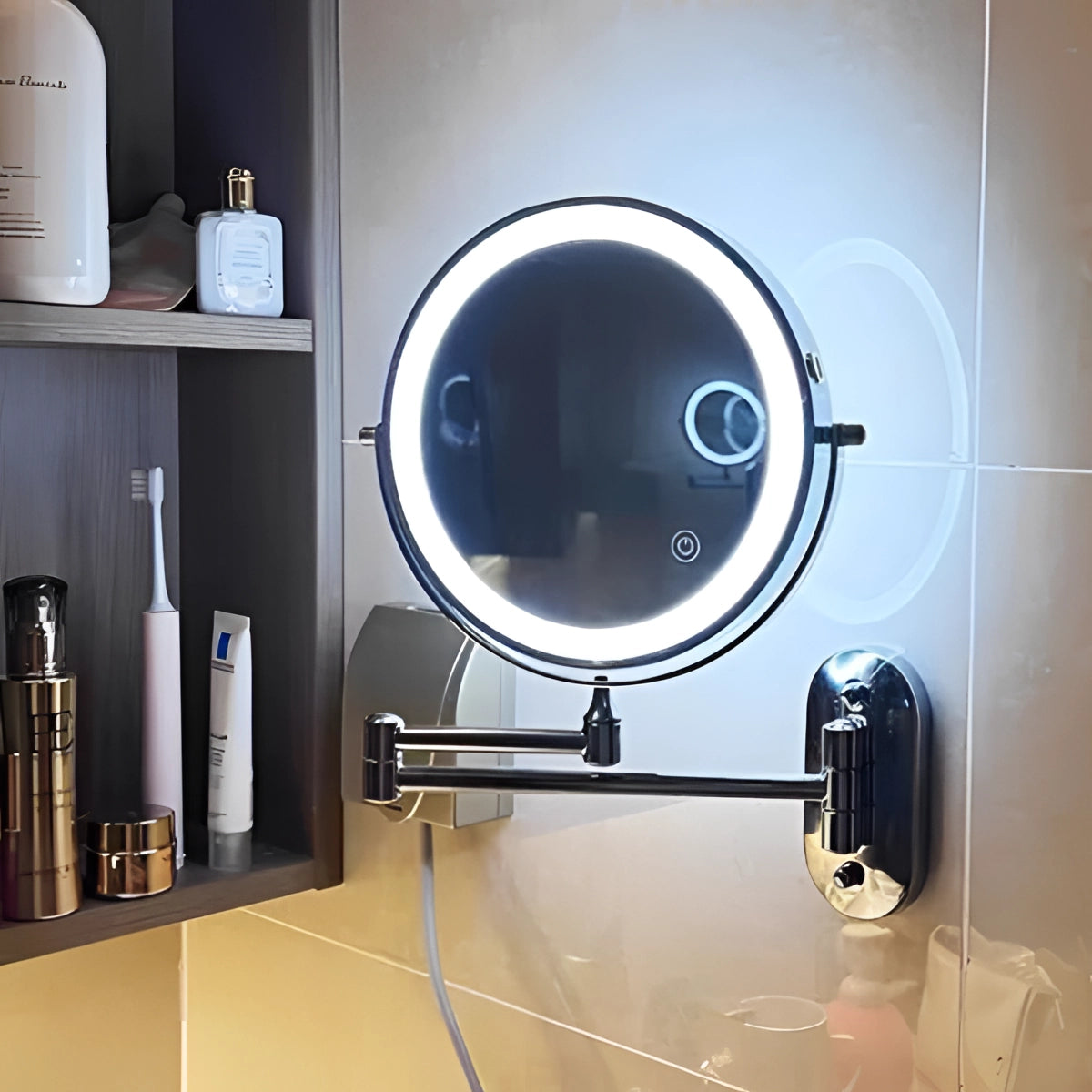 Wall-mounted LED lighted magnifying makeup mirror with adjustable touch sensor, mounted on a shelf next to various bathroom items.