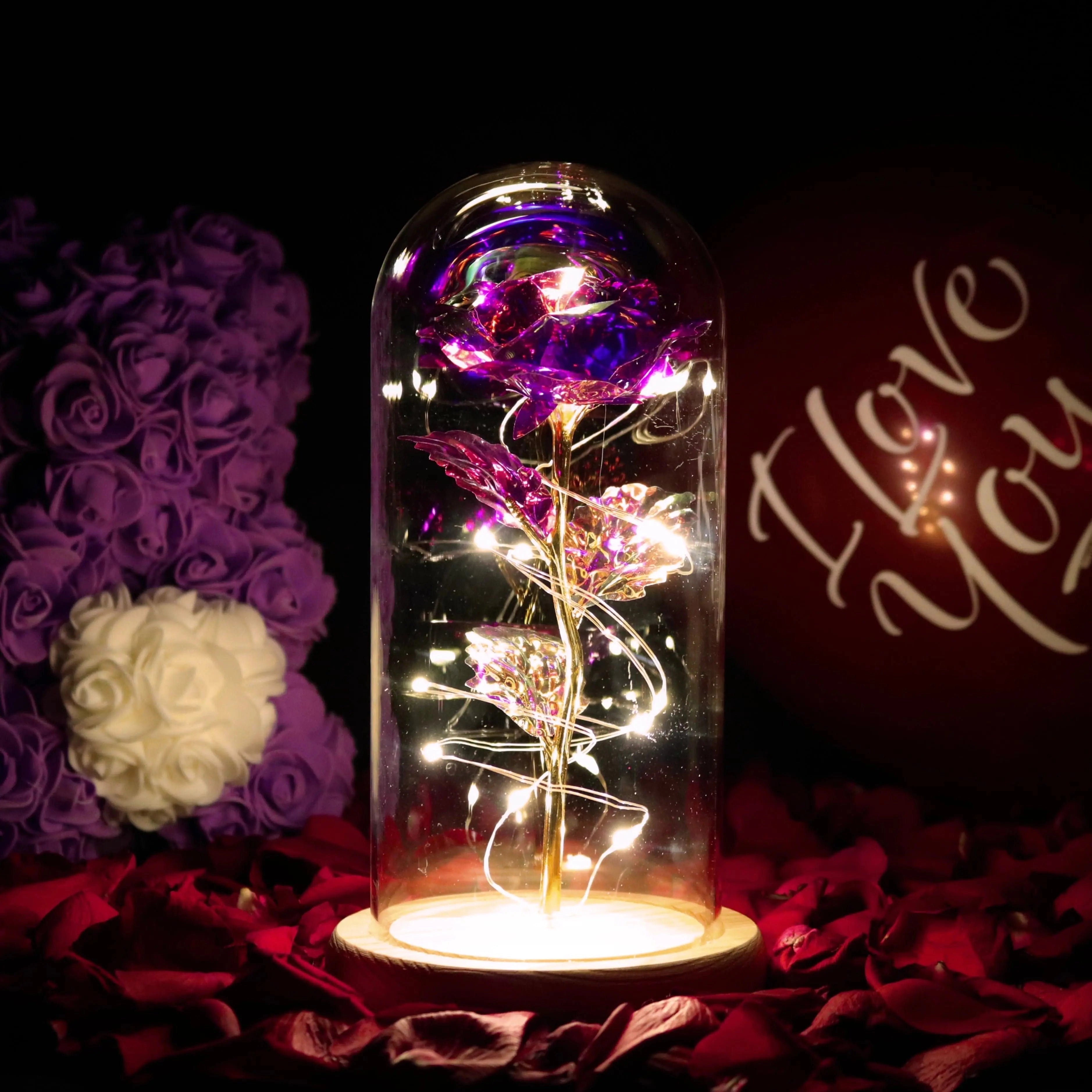 Amethyst Purple LED Rose Dome featuring an enchanted rose illuminated with delicate fairy lights, set within a clear glass dome. The decor piece is positioned near a window, casting a soft, enchanting glow perfect for adding an ornamental and whimsical touch to any setting.