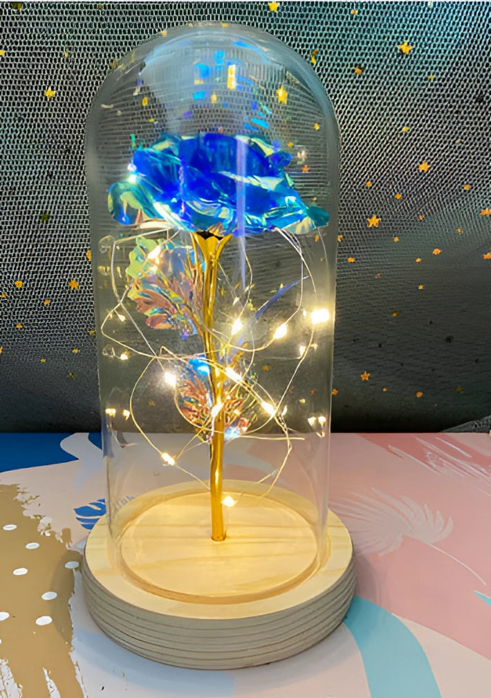 Sapphire blue LED rose encased in a glass dome with delicate fairy lights, creating an enchanting and artistic decorative piece.