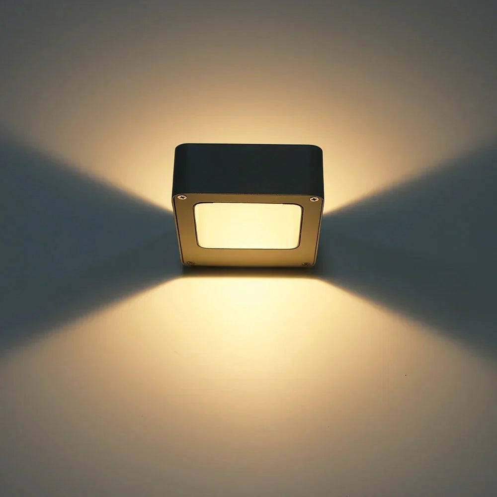 Modern square LED wall sconce with a weather-resistant exterior design, featuring a sleek metal frame and a rectangular shape suitable for outdoor lighting.