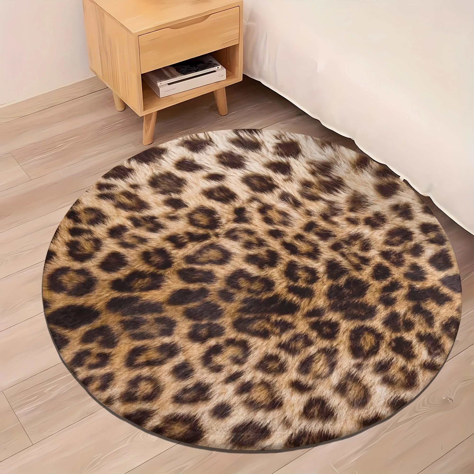 Leopard print round rug with faux fur texture on a hardwood floor.