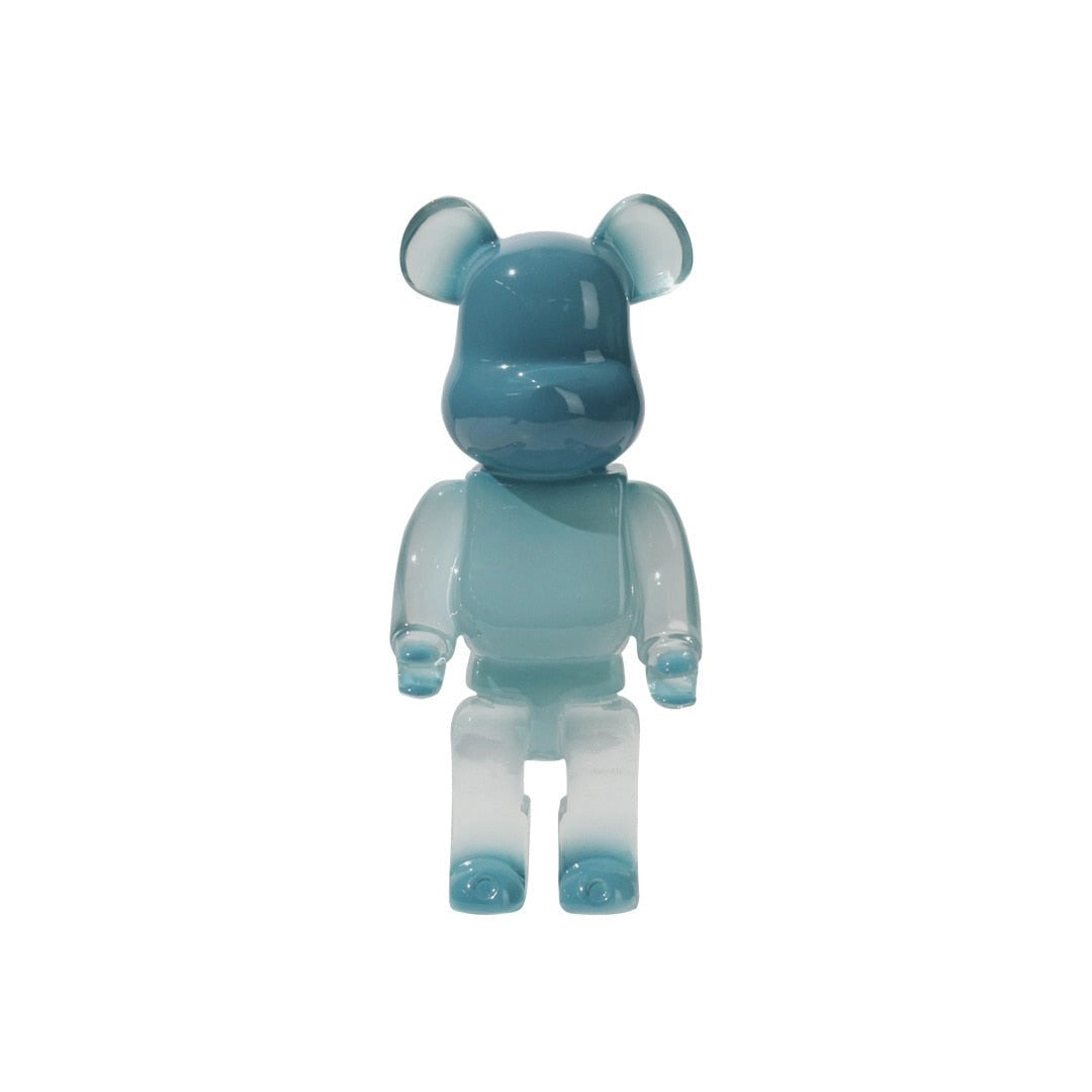 
A limited edition clear vinyl Bearbrick designer art toy figurine in sky blue color, featuring a unique fictional character design with electric blue accents.