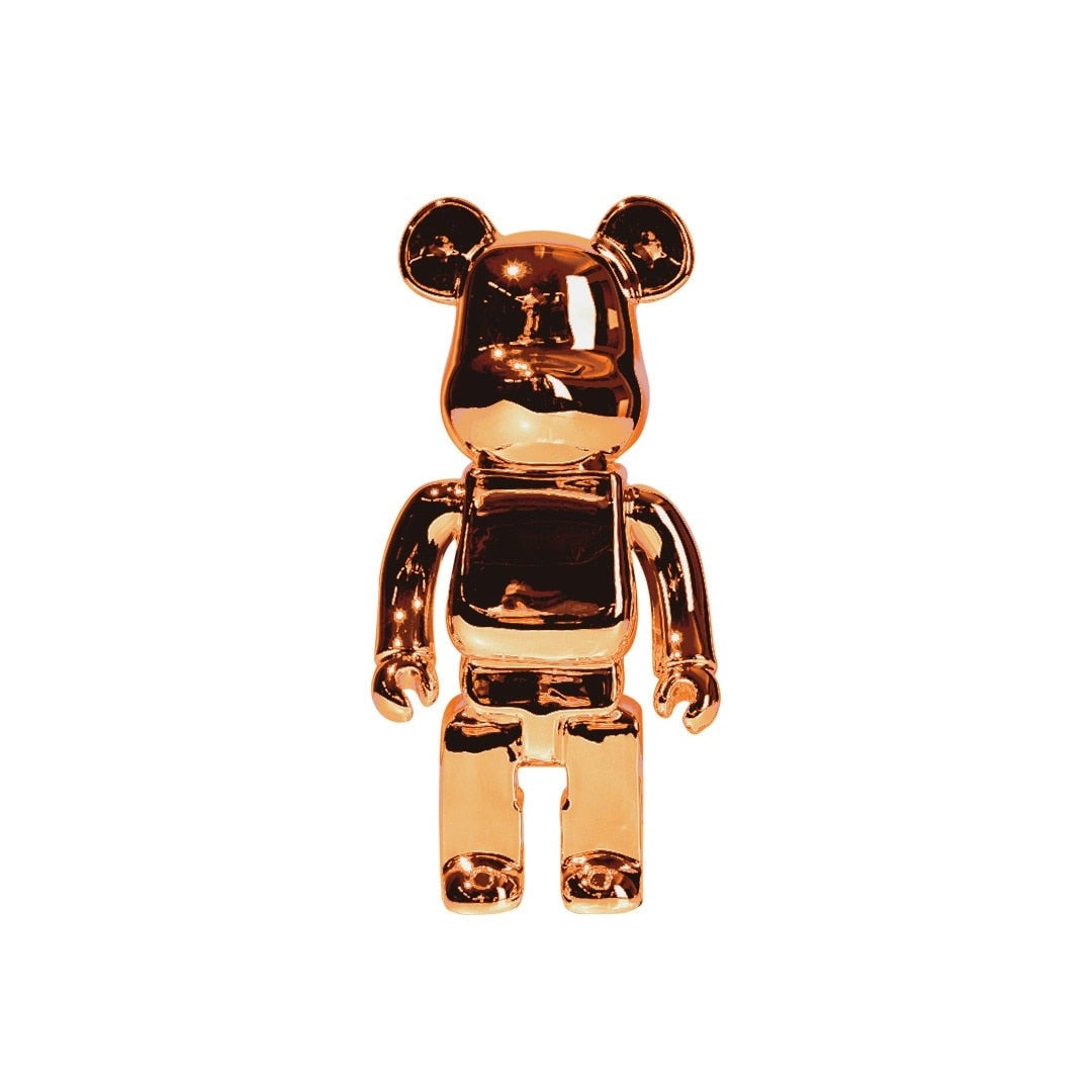 Limited edition clear vinyl Bearbrick designer art toy figurine in orange, featuring a bear-like design with stylized elements, a glossy finish, and intricate details that resemble a fictional character.