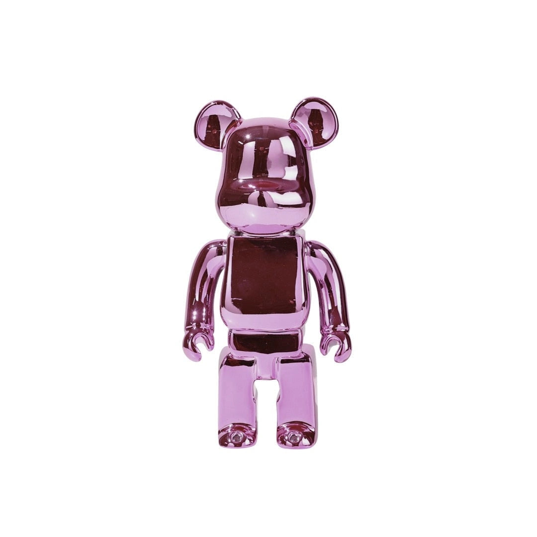 Limited edition clear vinyl Bearbrick designer art toy figurine in a rose variant, featuring a vibrant magenta and violet color scheme, depicted with a gestured pose.