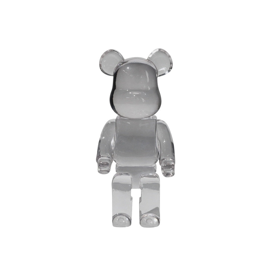 Limited Edition Clear Vinyl Bearbrick figurine, a designer art toy featuring a transparent bear-shaped body with articulated arms and a sleek, modern aesthetic.