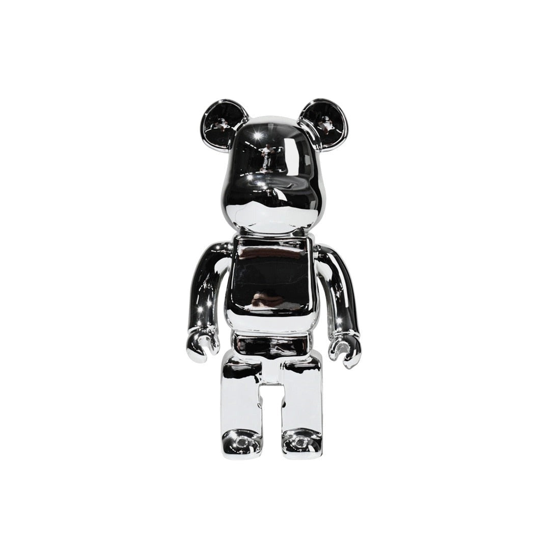 Limited Edition Clear Vinyl Bearbrick Designer Art Toy Figurine in Silver, featuring a transparent bear-shaped body with silver accents, showcasing a unique artistic design.