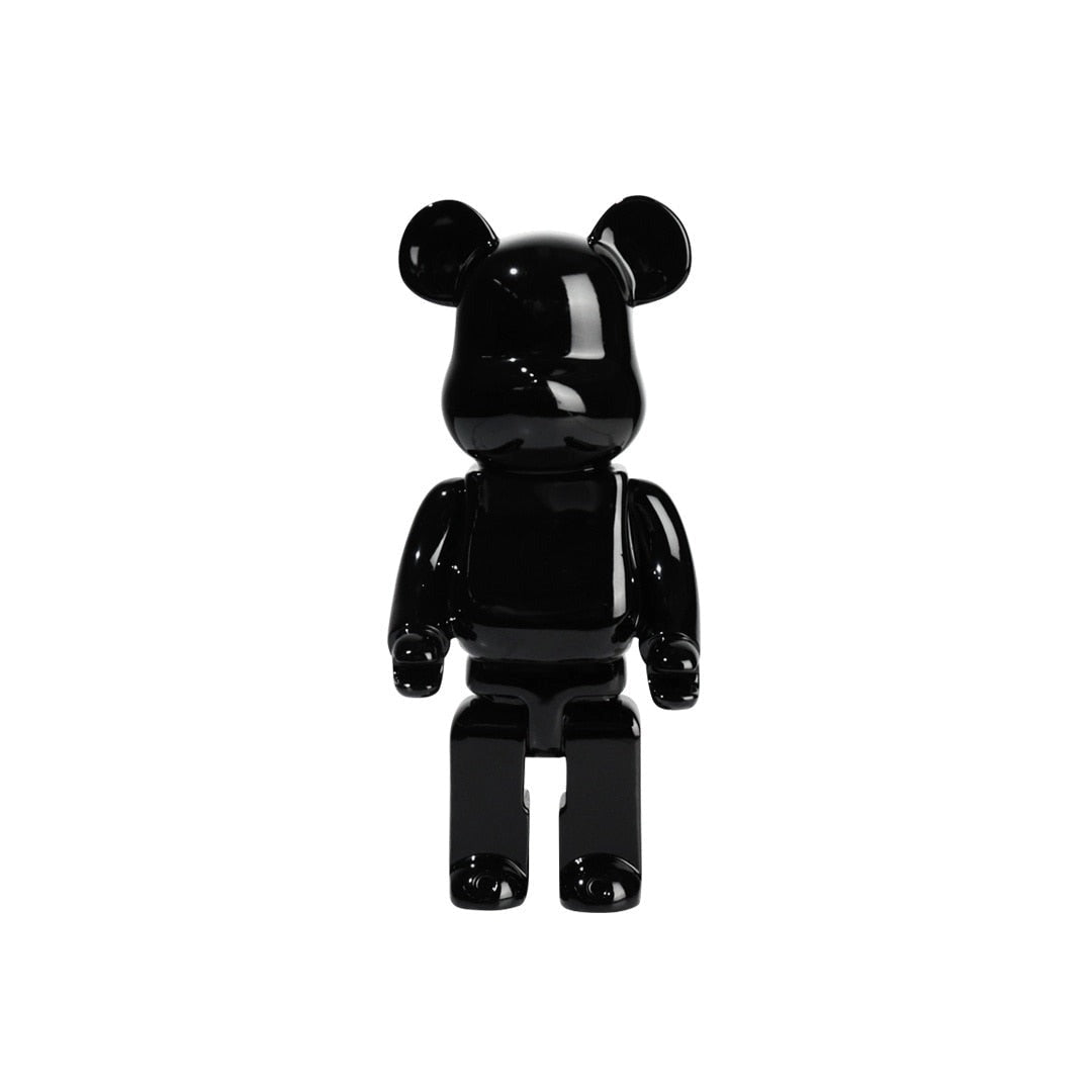 Clear vinyl Bearbrick designer art toy figurine in black, featuring distinct bear-like snout, articulated arms, and sleek outerwear design.