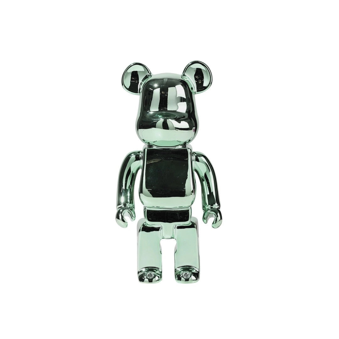 Limited edition clear vinyl Bearbrick designer art toy figurine in green, featuring a whimsical design with unique detailing, resembling an action figure with a fashion-forward aesthetic.