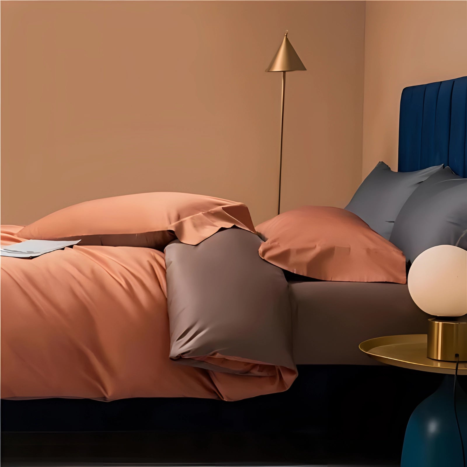 Luxury bedding set on a bed with a wooden frame, featuring high-end Egyptian cotton linens in a warm orange shade, illuminated by soft lighting.