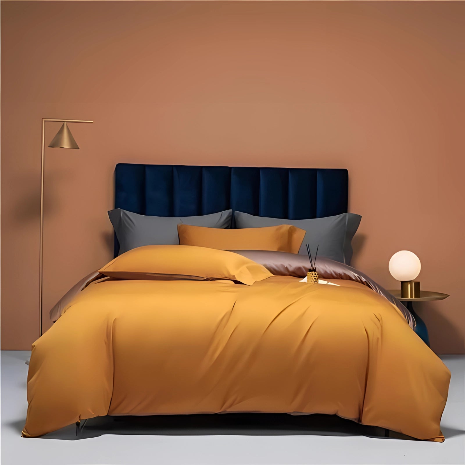 Orange king-sized luxury bedding set made from high-end Egyptian cotton, displayed on a bed with a wooden frame, complemented by pillows and a nearby lamp.