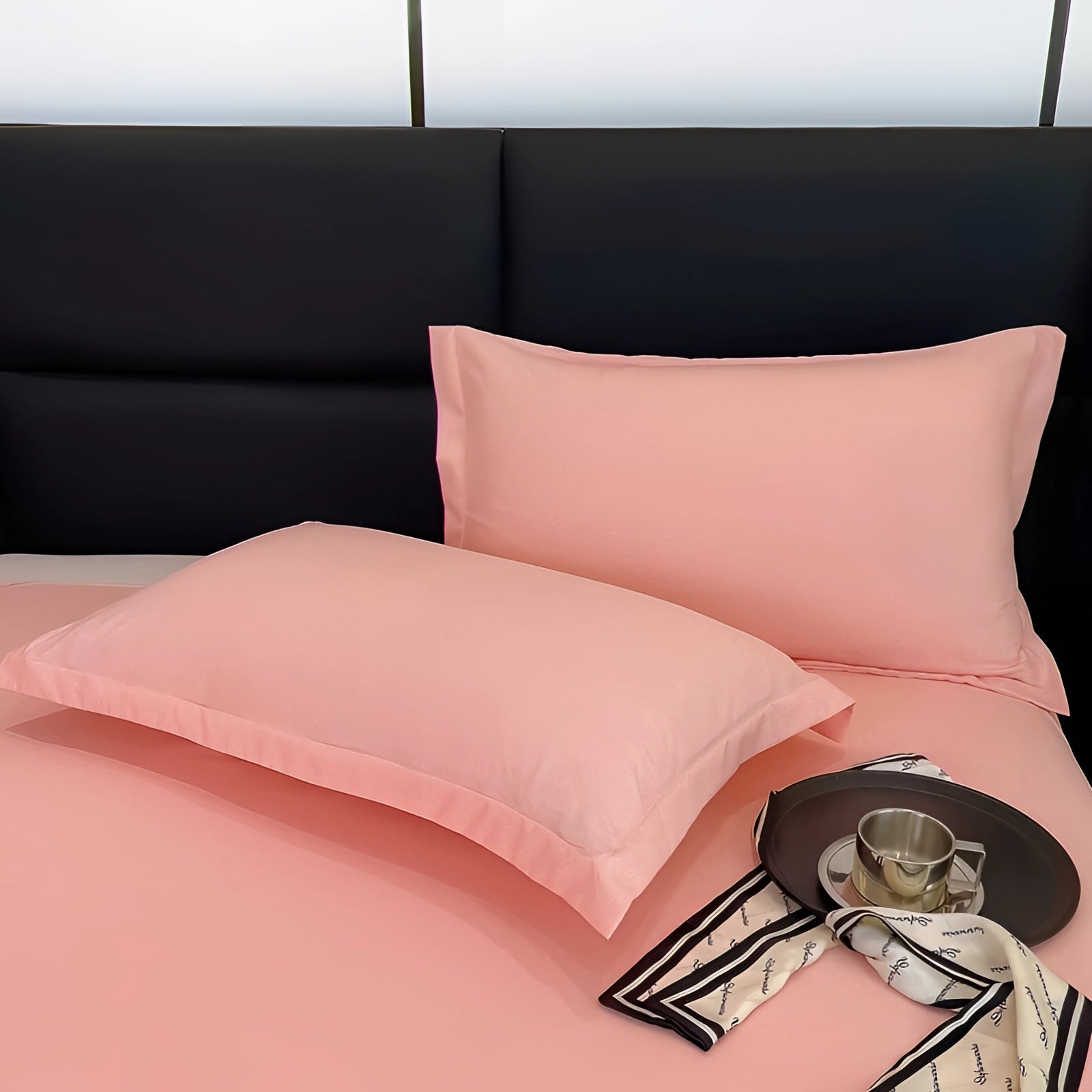 Luxury blush pink silk pillowcase on a bed with a wooden frame, showcasing a rectangular design that is hypoallergenic and hair-friendly, enhancing comfort and interior design aesthetics.