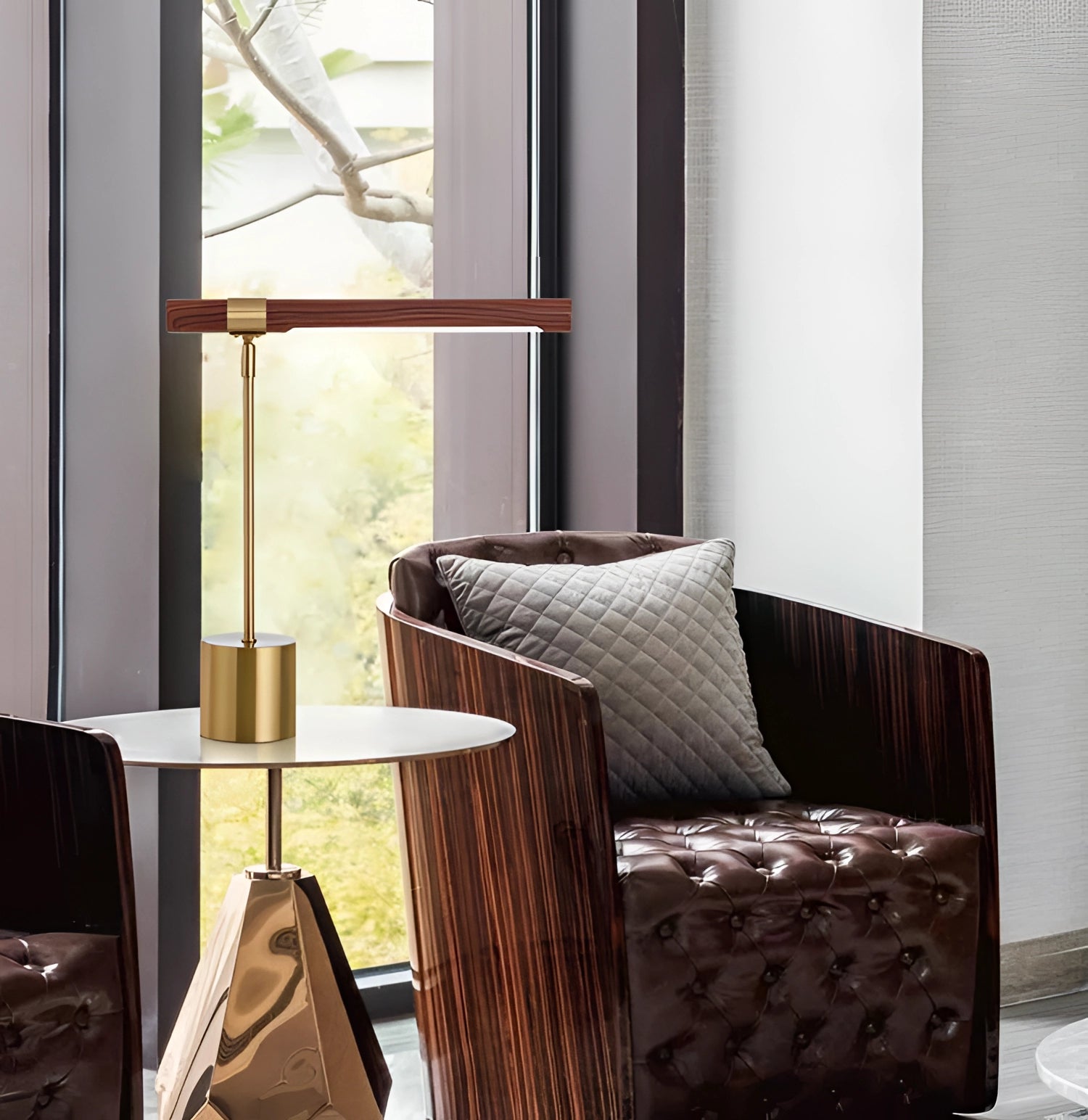 Luxury brass and wood adjustable desk lamp with modern design on a wooden table in a stylish interior setting.