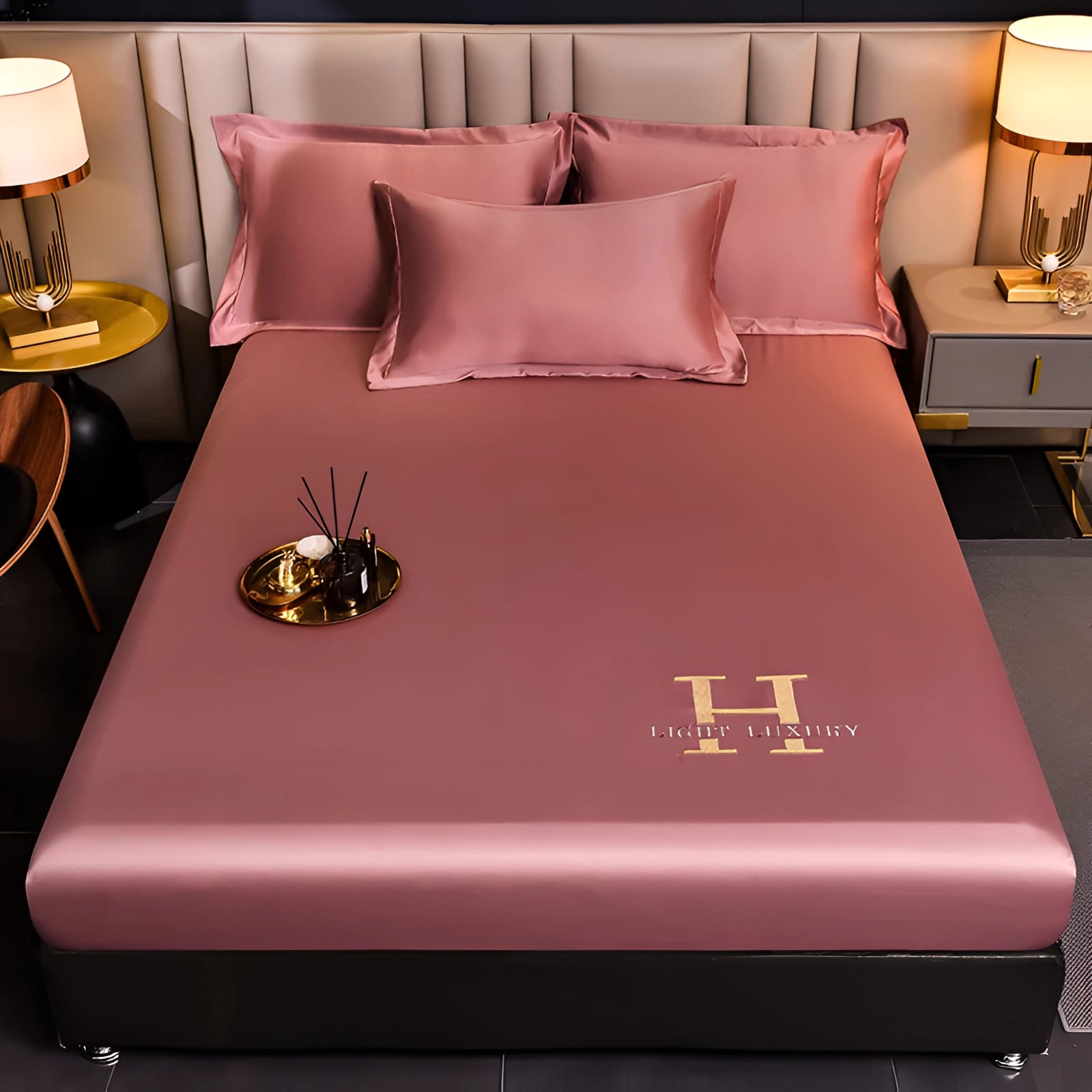 Luxury pink silk bedding set in a 200x220 cm size, featuring premium satin sheets and matching pillowcases. The image showcases the bedding's smooth and lustrous texture, set against a stylish interior with soft lighting and wooden elements.