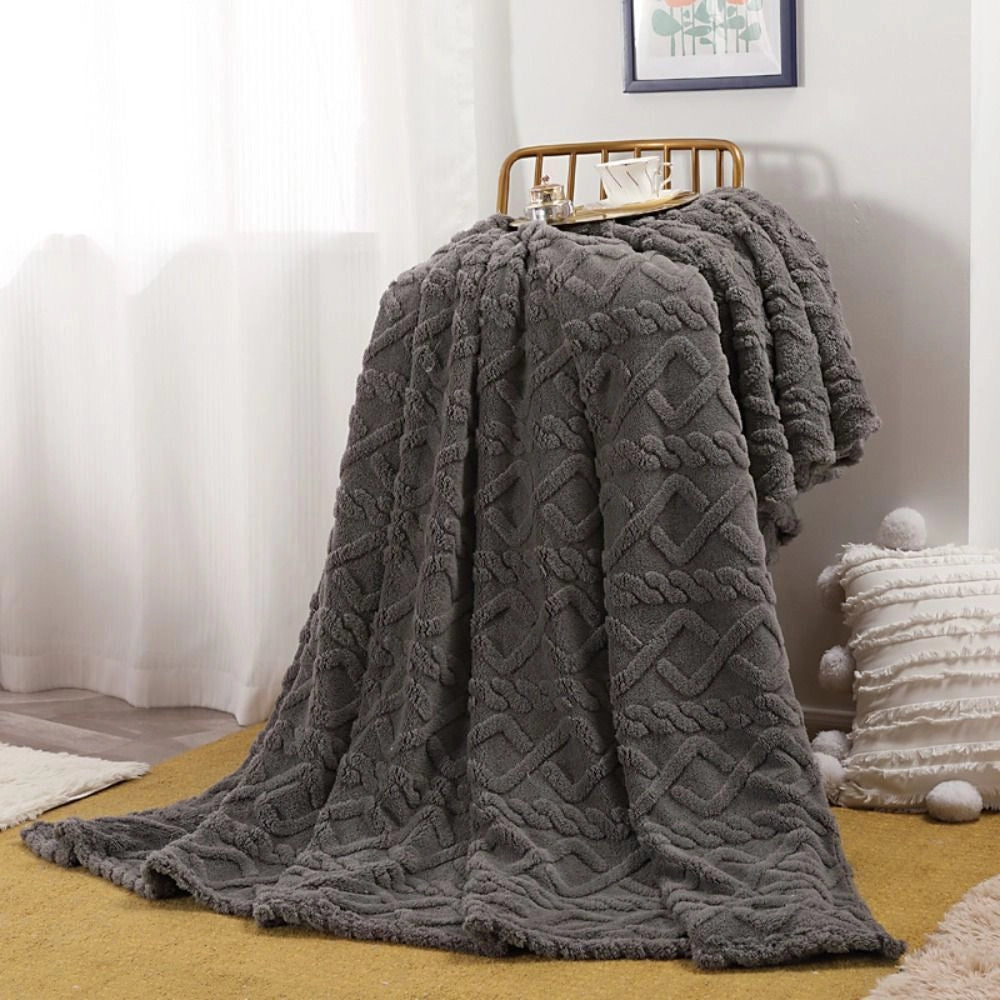 Luxurious black cable knit throw blanket measuring 200x230cm, elegantly draped on a floor with a detailed pattern, showcasing its cozy and high-quality texture.