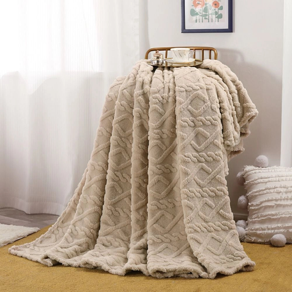 Elegant cream luxury cable knit throw blanket in beige, measuring 200x230cm, draped over a clothes hanger, showcasing its intricate pattern and texture.