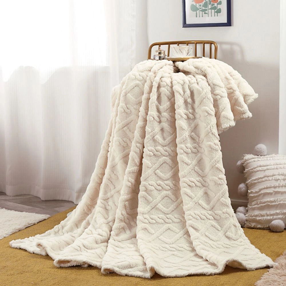 Elegant cream luxury cable knit throw blanket draped over hardwood flooring, showcasing its cozy and high-quality texture in an ivory white color, measuring 200x230cm.