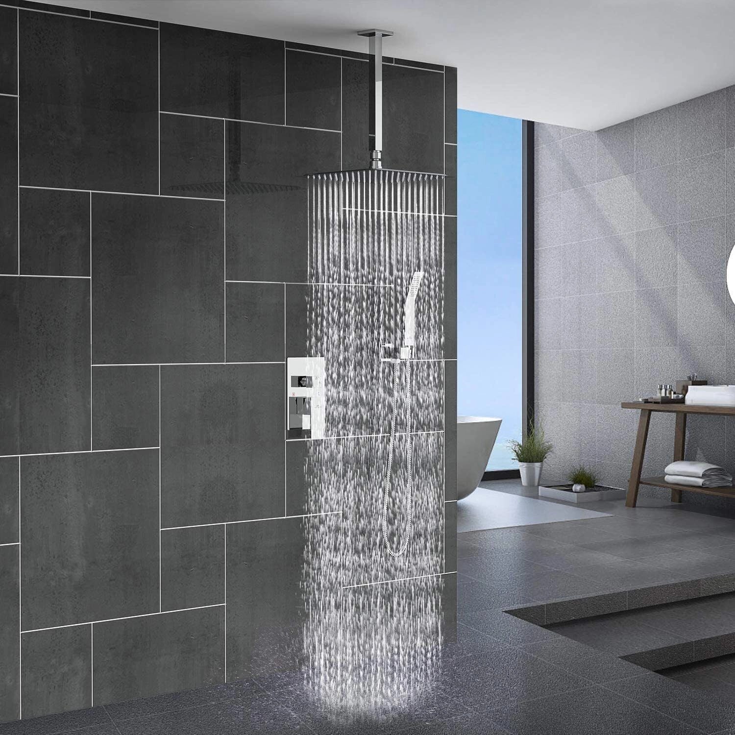 Luxurious chrome high-pressure wall-mount rainfall shower head installed against a tiled bathroom wall, with visible showerhead design and chrome finish reflecting the light.