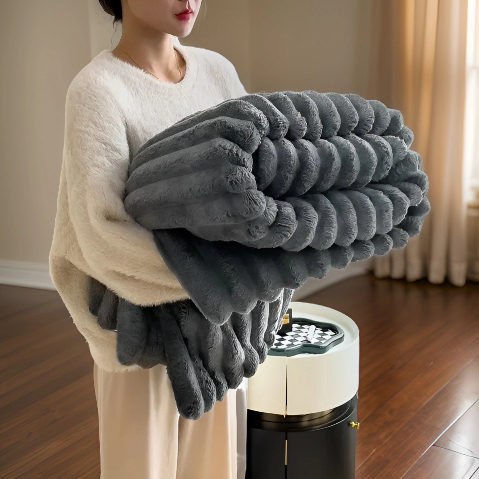 Luxurious chunky knit blanket in dark gray draped over a wooden surface, showcasing its soft, plush texture suitable for modern decor.