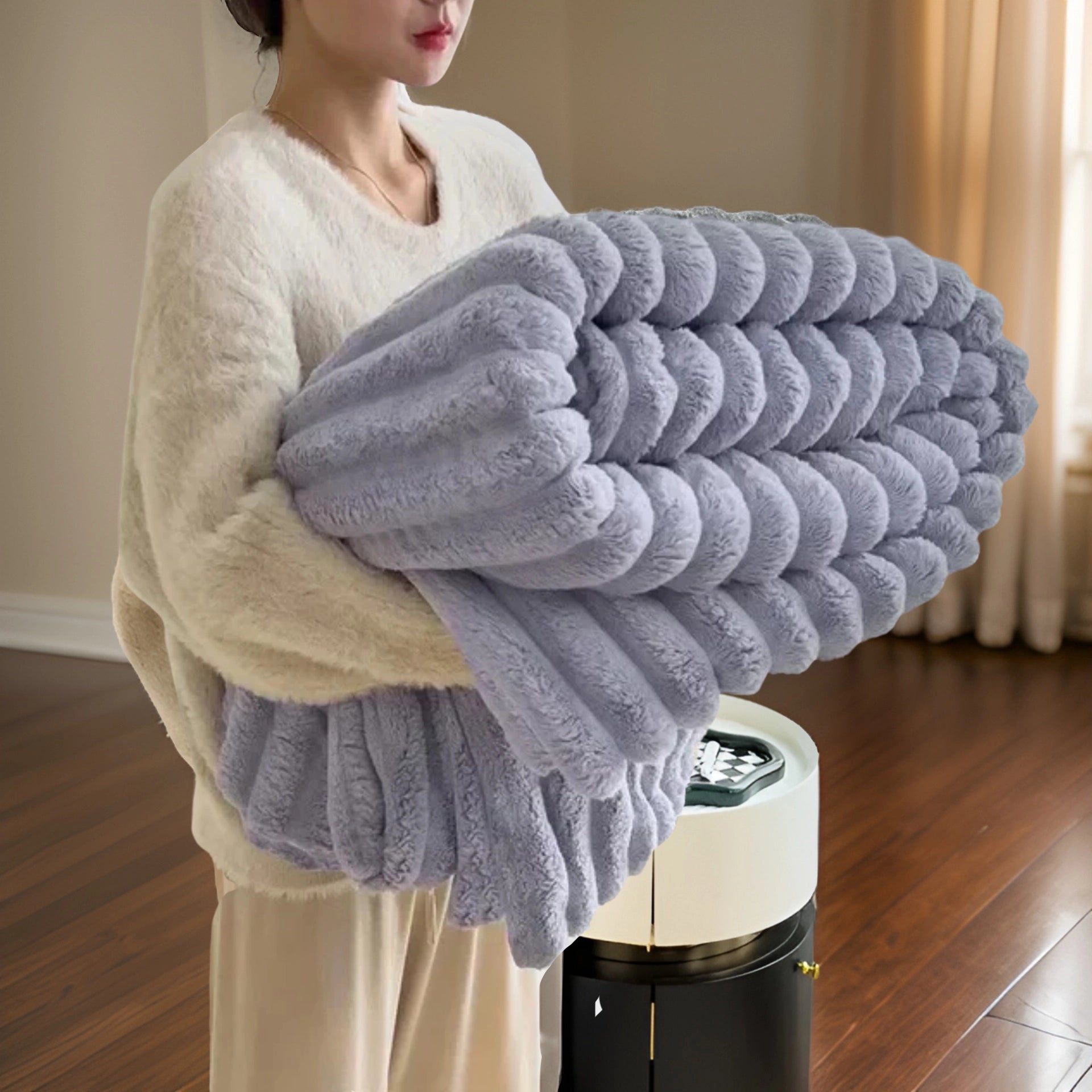 Luxurious chunky knit blanket in a soft purple color, measuring 200x230cm, draped over a wooden surface, showcasing its plush and modern design as an elegant home decor piece.