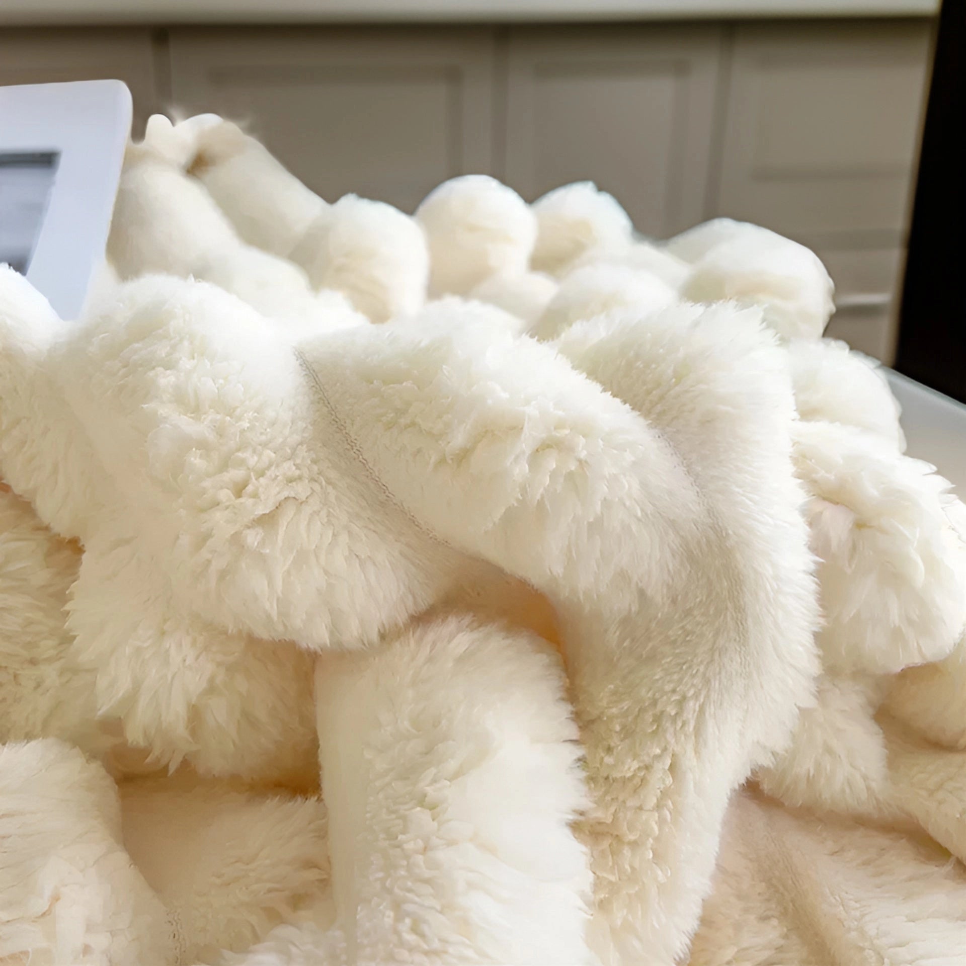 Chunky knit blanket made of soft wool fibers, offering a plush and luxurious texture, ideal for modern decor and cozy comfort.