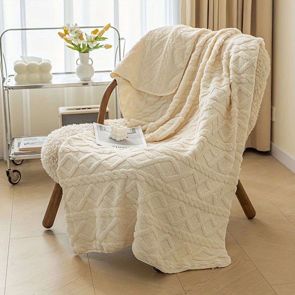 Luxury cream geometric throw blanket on plush armchair with houseplant in flowerpot nearby, situated on wooden flooring near a window, creating a cozy and comfortable setting.