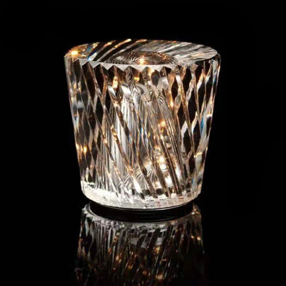 Luxury crystal candle holder made of diamond-cut glass, intricately designed to resemble elegant stemware and barware, with a transparent, high-end finish.