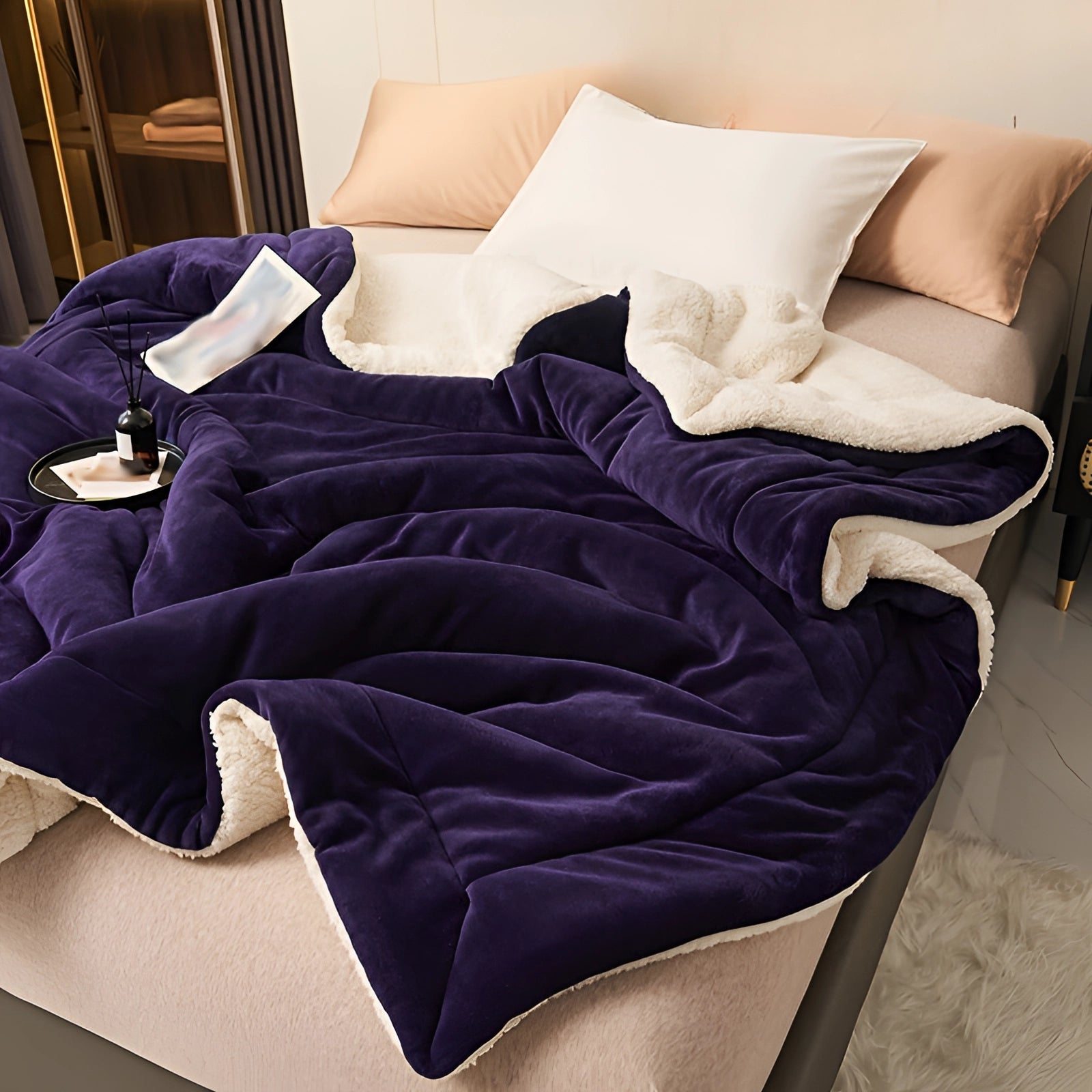 Luxury deep purple velvet blanket with plush sherpa lining draped elegantly, showcasing its rich color and soft texture, perfect for adding comfort and style to any setting.