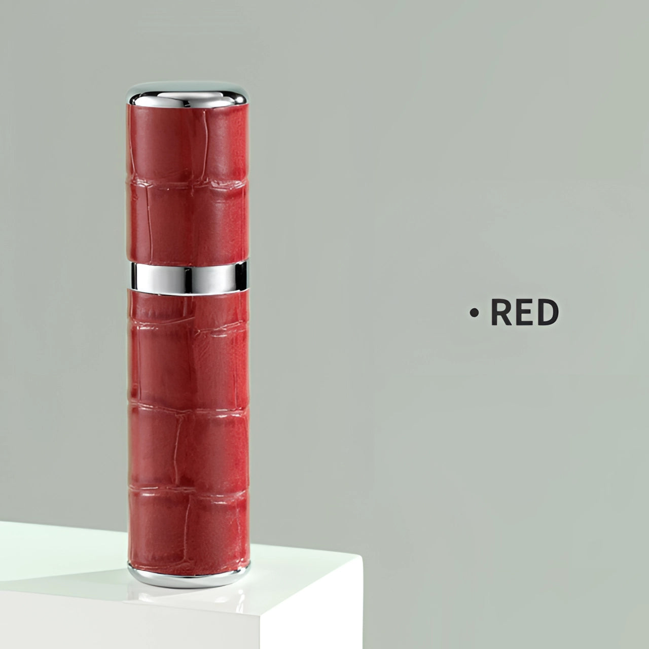 Luxury designer lipstick with a crocodile skin texture in a bold red shade, featuring a sleek cylindrical shape and high-end design elements.