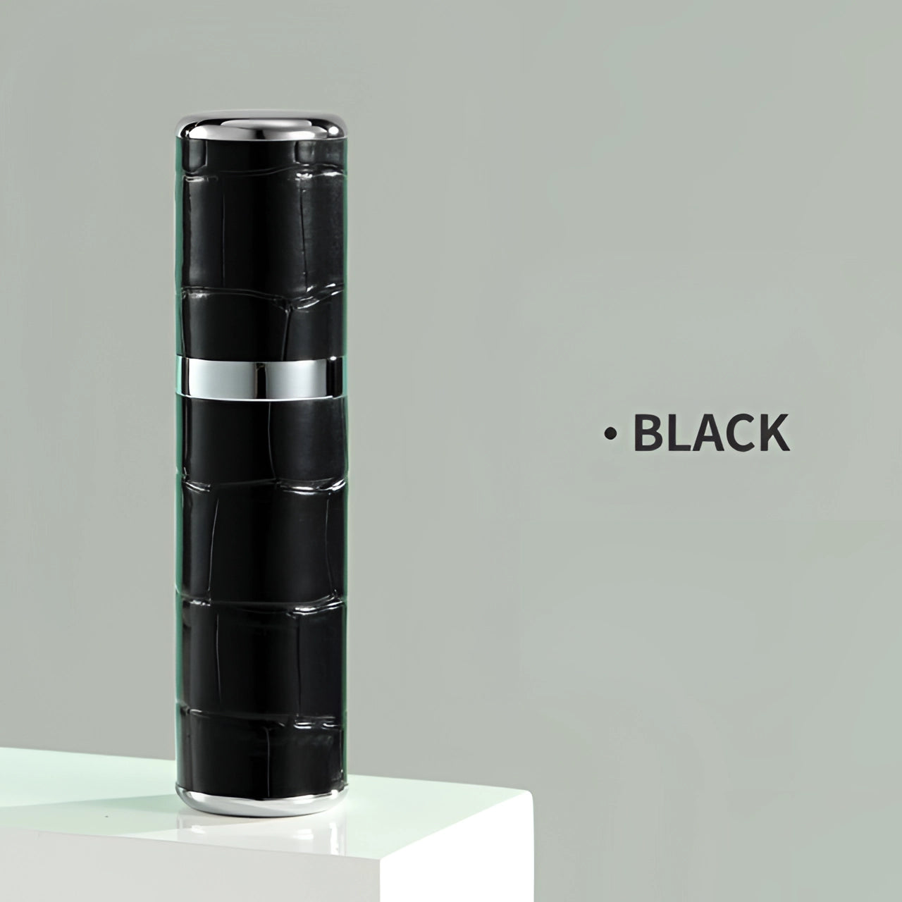 Luxury designer lipstick in a sleek black tube with a crocodile skin texture, representing high-end makeup.