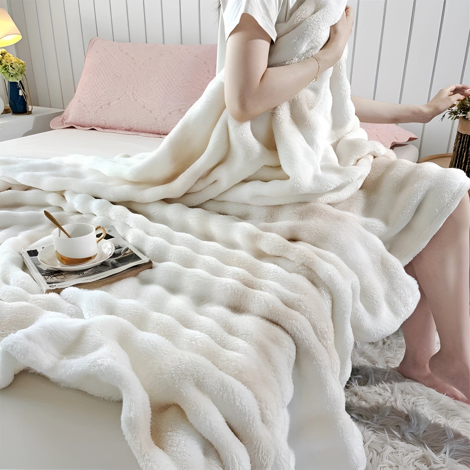 Luxury faux fur blanket draped over a wooden surface, showcasing its plush texture and cozy beige color.