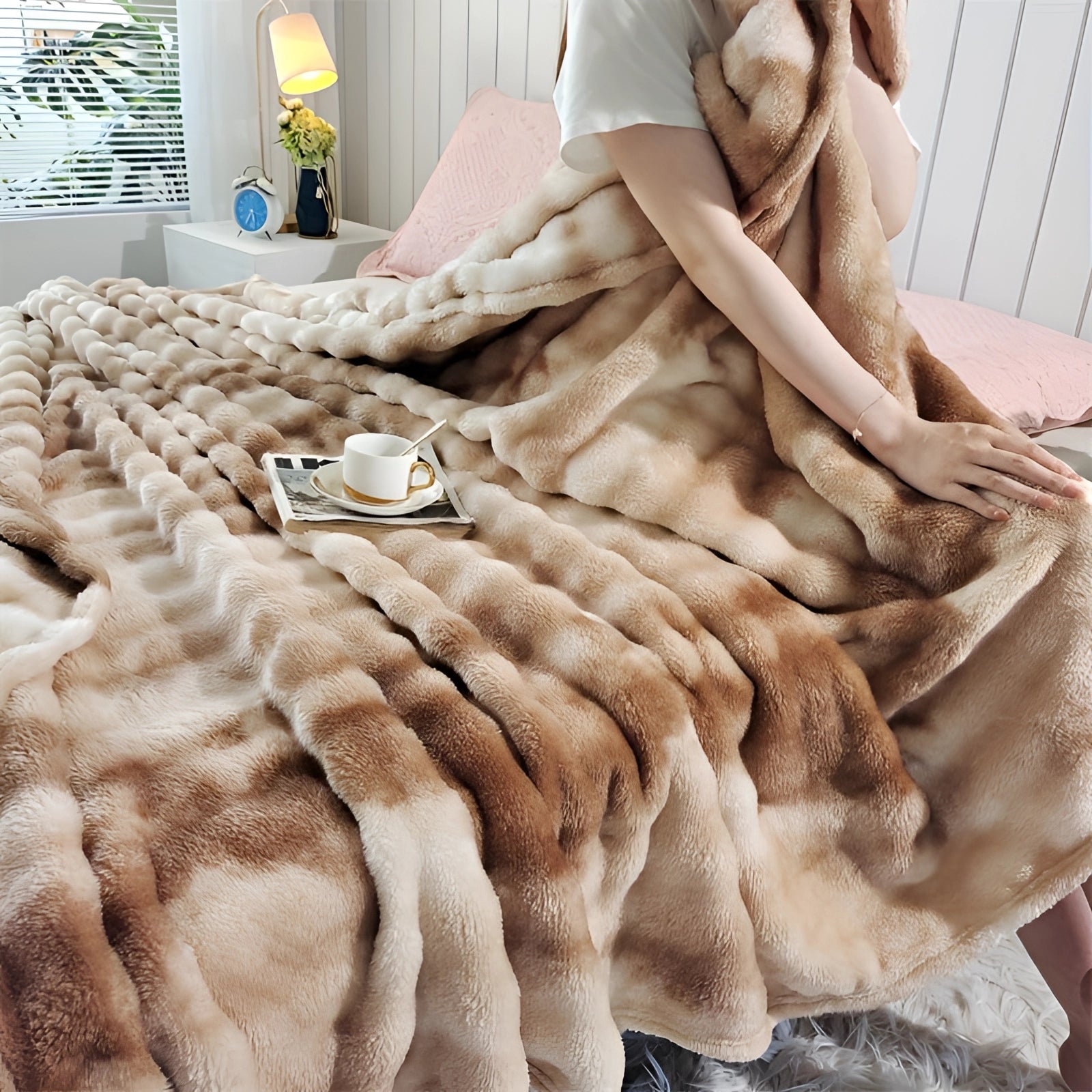 Luxury faux fur blanket in a plush beige color, draped elegantly over a wooden surface, showcasing its cozy and stylish design.