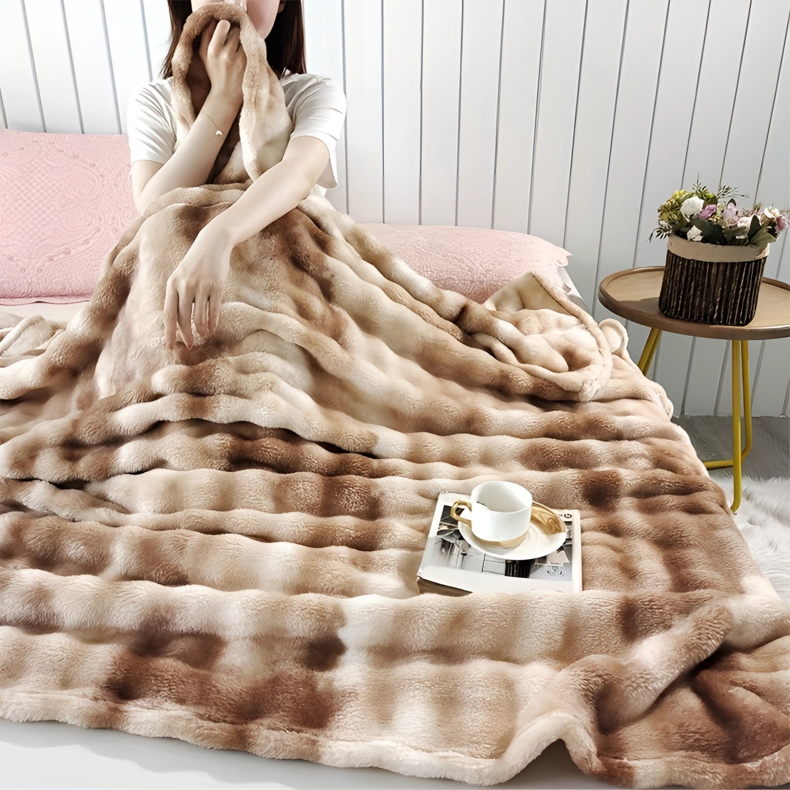 Luxurious faux fur blanket in a rich brown color, elegantly draped over a sofa, surrounded by cozy decor elements including a wooden floor, potted houseplants, and plush linens, creating an inviting and stylish living space. Blanket measures 200x230cm.