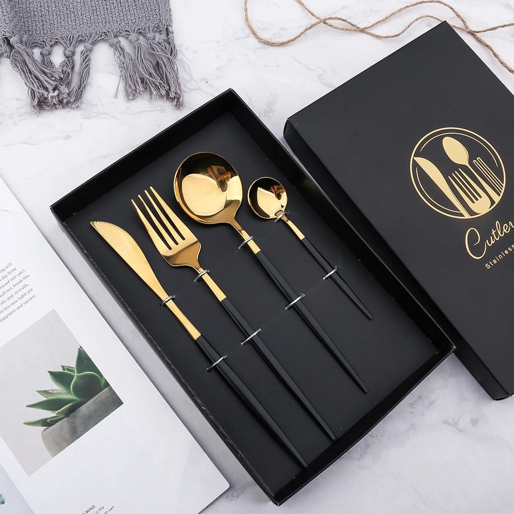 Elegant luxury gold cutlery set featuring sleek gold and black design, elegantly arranged on a table setting, showcasing its modern and sophisticated style.