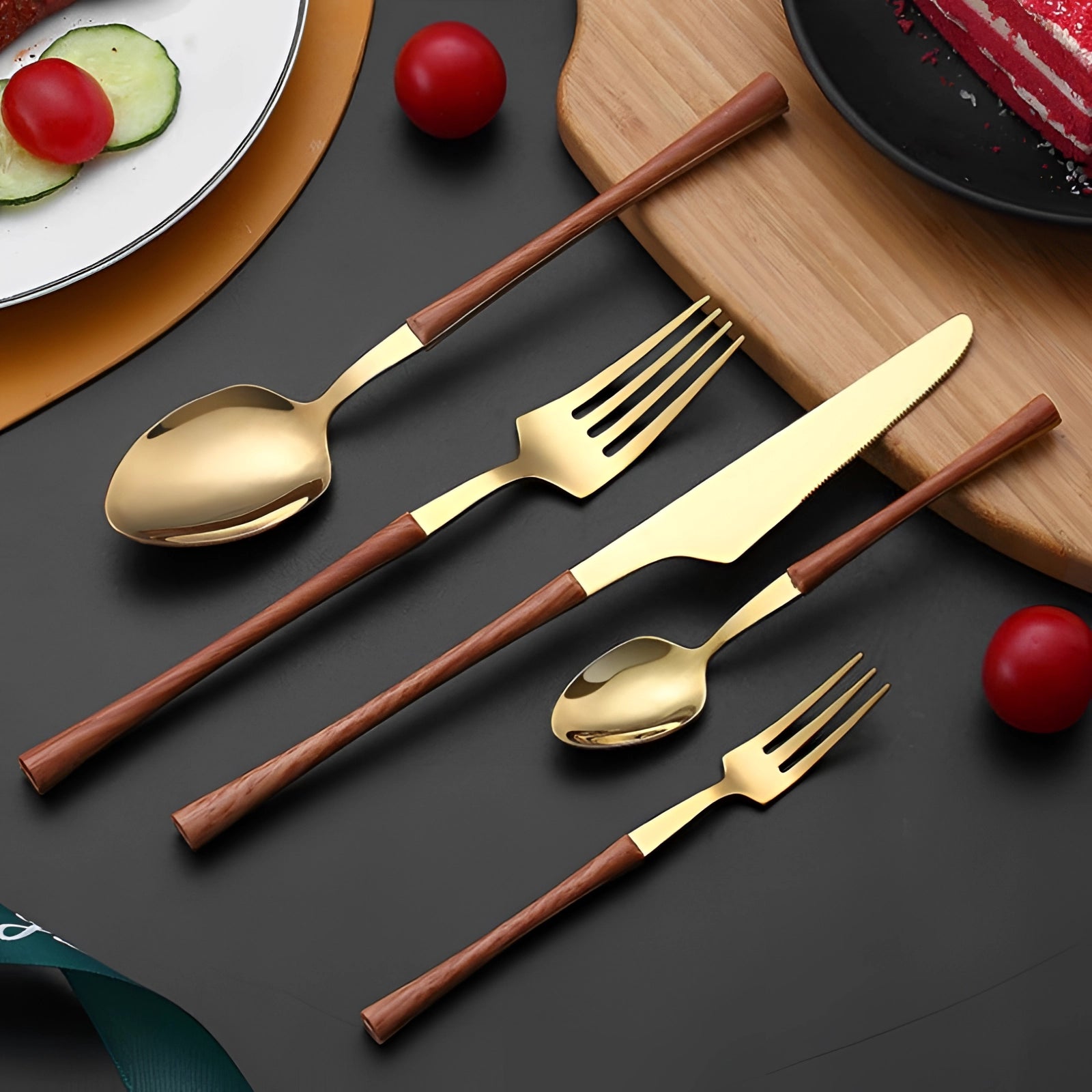 Elegant Luxury Gold Marble Handle Cutlery Set consisting of five pieces featuring a combination of wood and gold. This designer flatware is displayed alongside a matching plate and platter, showcasing its sophisticated tableware style, ideal for enhancing any dining experience.