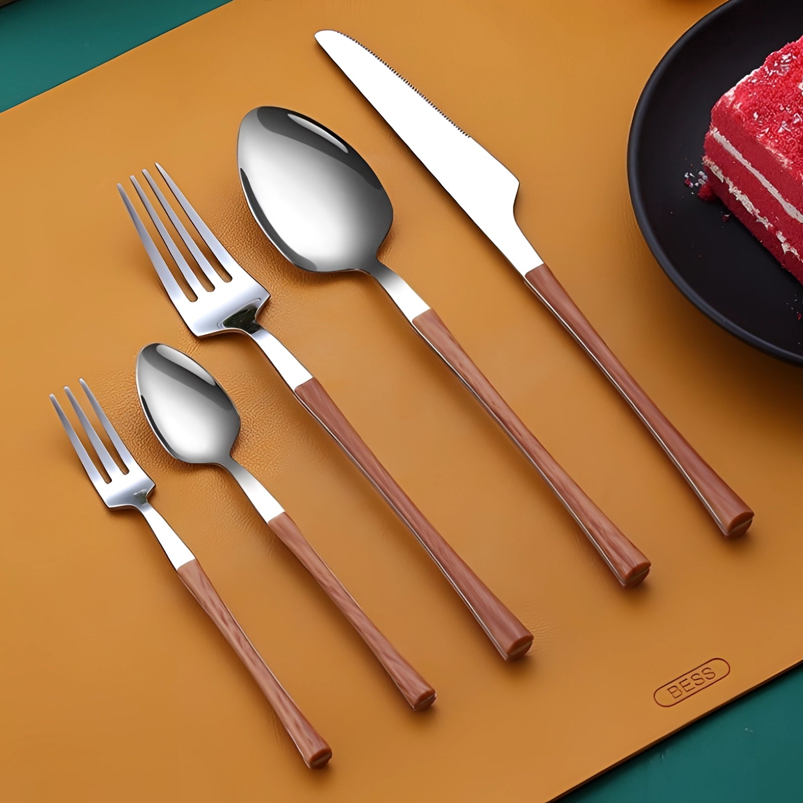 Elegant cutlery set featuring a luxury gold marble handle design, with five pieces including a fork, knife, spoon, and other utensils, set on a wooden surface.