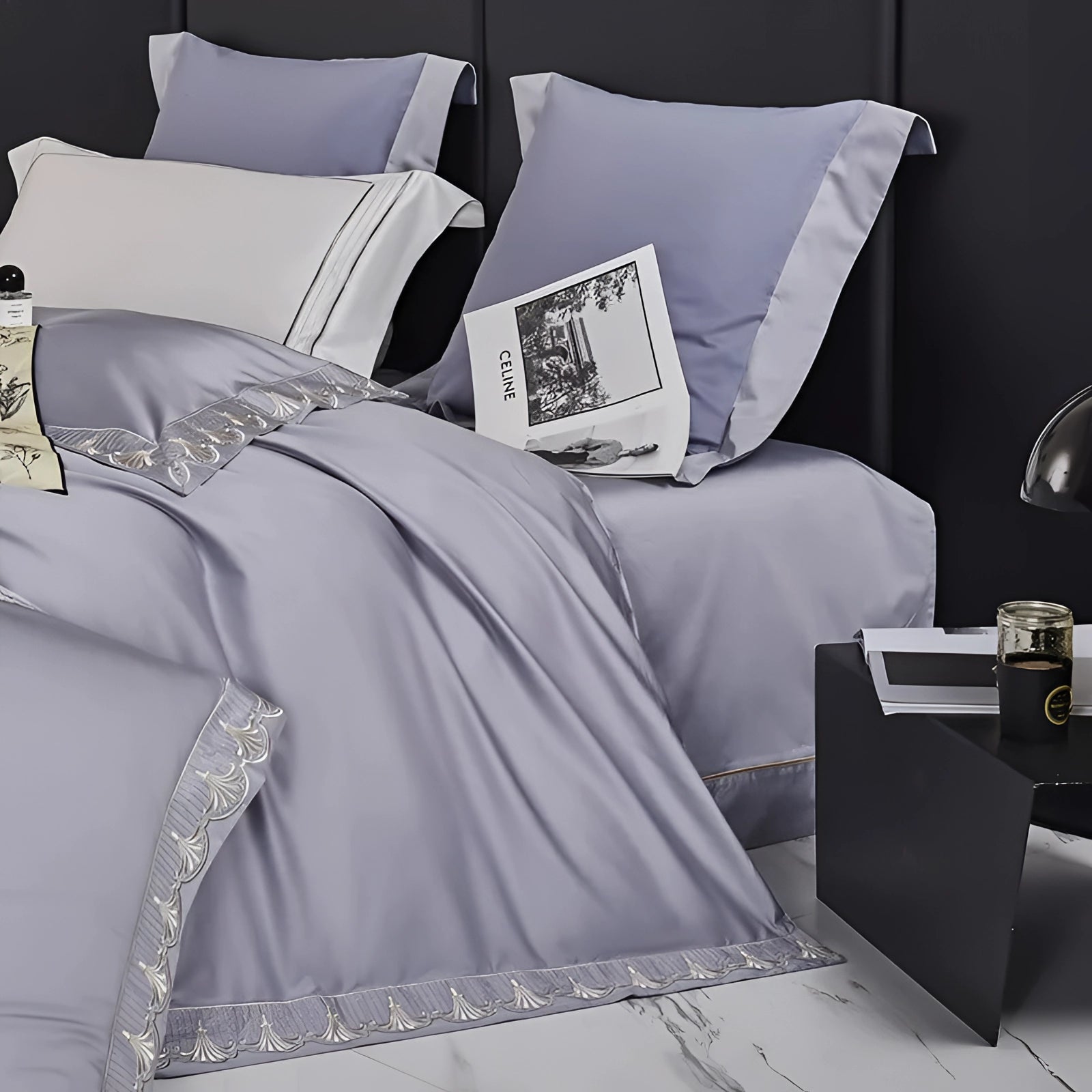 Luxury gray cotton bedding set featuring a silk satin bedspread and matching pillow shams, styled in a comfortable and elegant interior design.