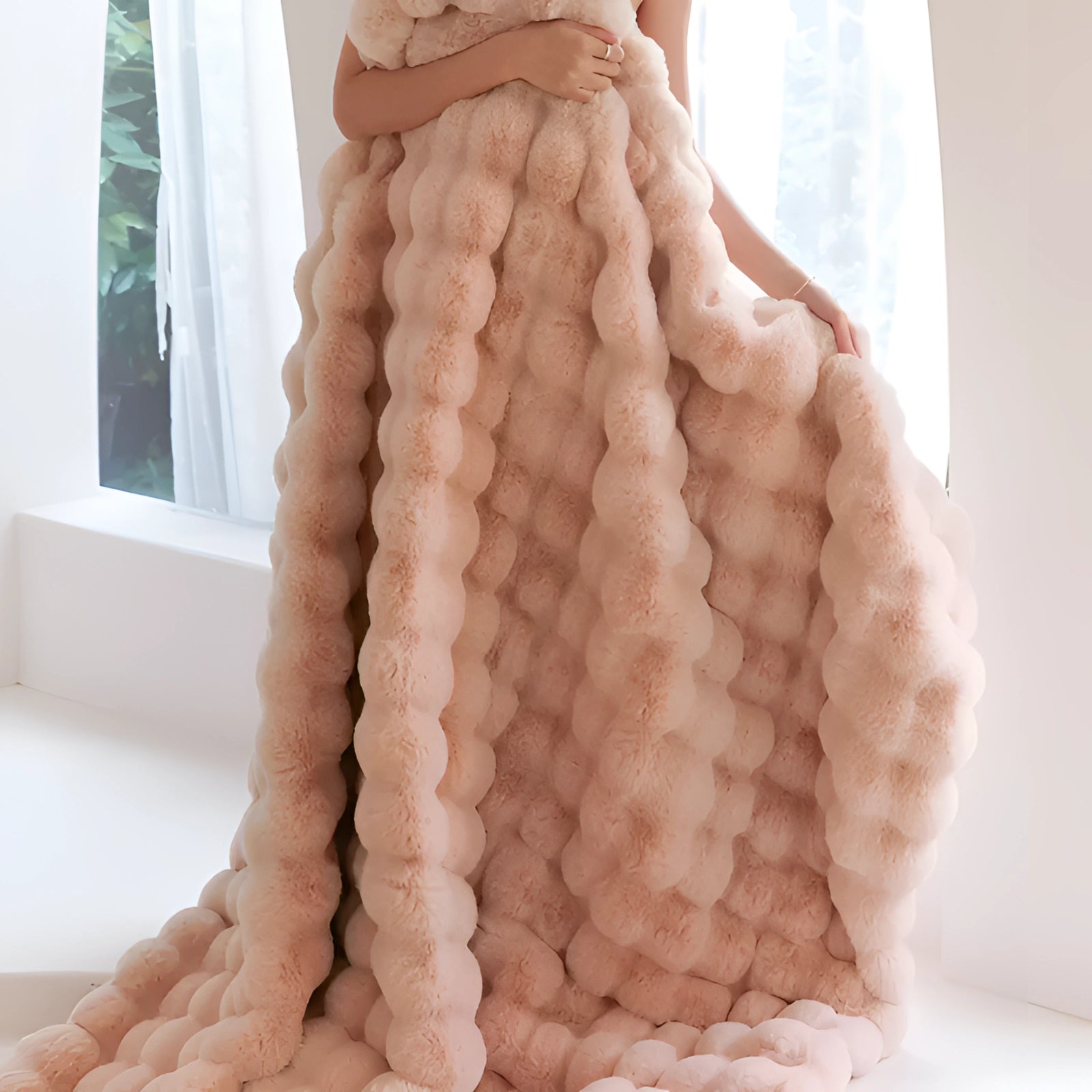 Luxurious pink faux fur blanket draped over a wooden surface, measuring 200 x 230 cm, adding a touch of plush softness and style to home decor.