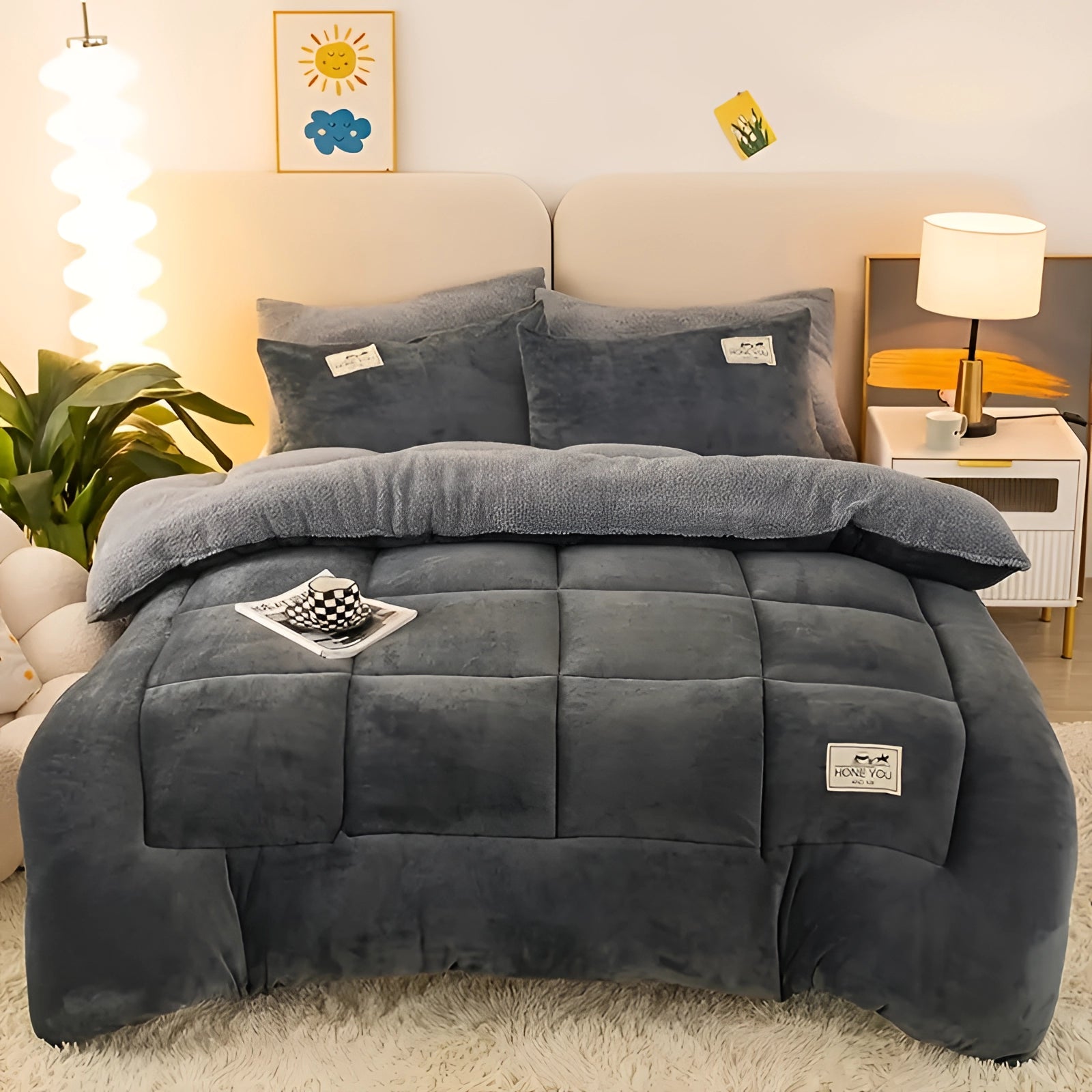 Luxurious gray velvet blanket draped over a stylish couch, set in a cozy room with warm lighting and a touch of greenery, providing a sense of comfort and elegance.