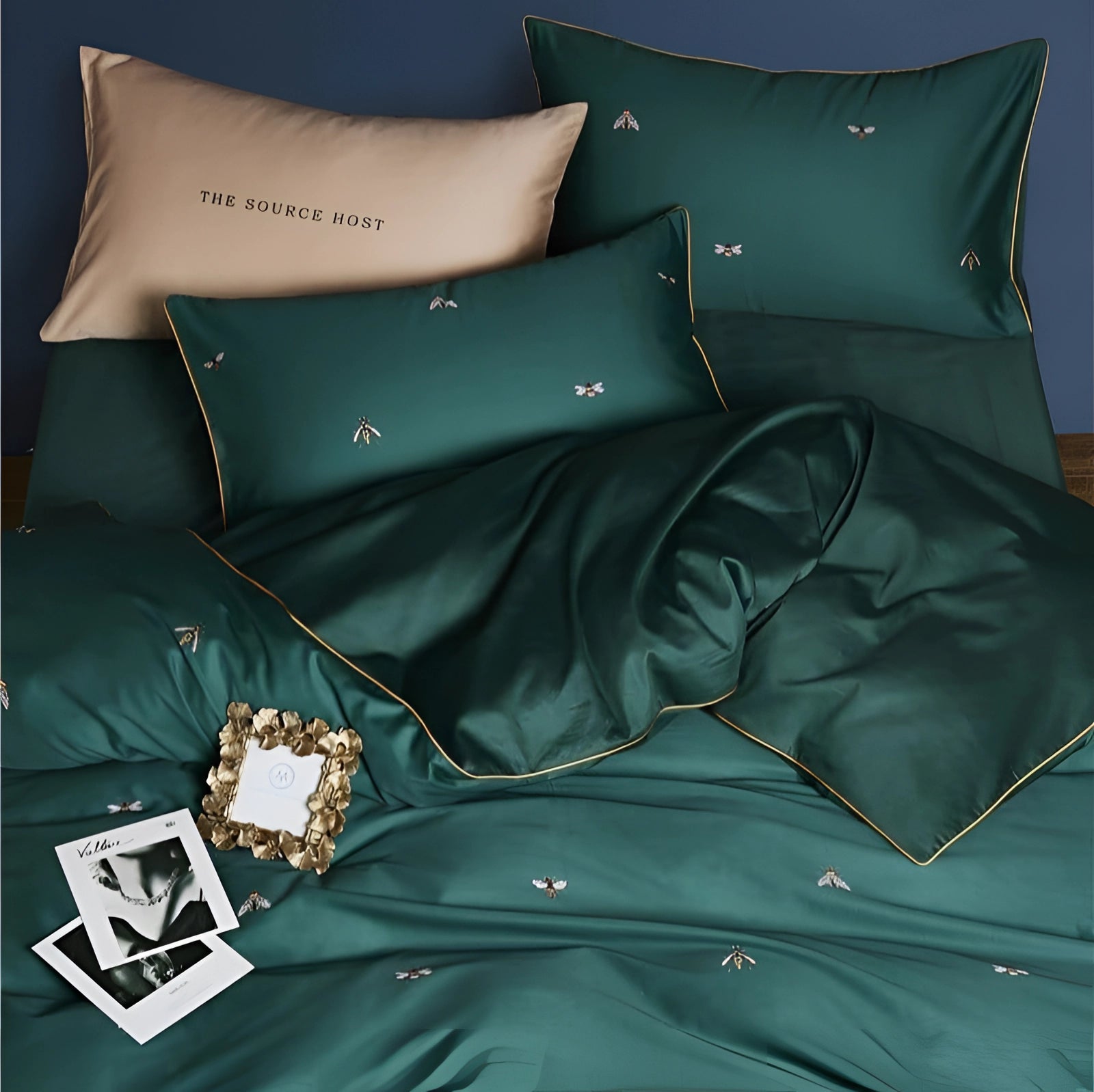 Luxurious green silk bedding set featuring a bee pattern, accompanied by embroidered pillowcases, showcasing a blend of comfort and elegance.