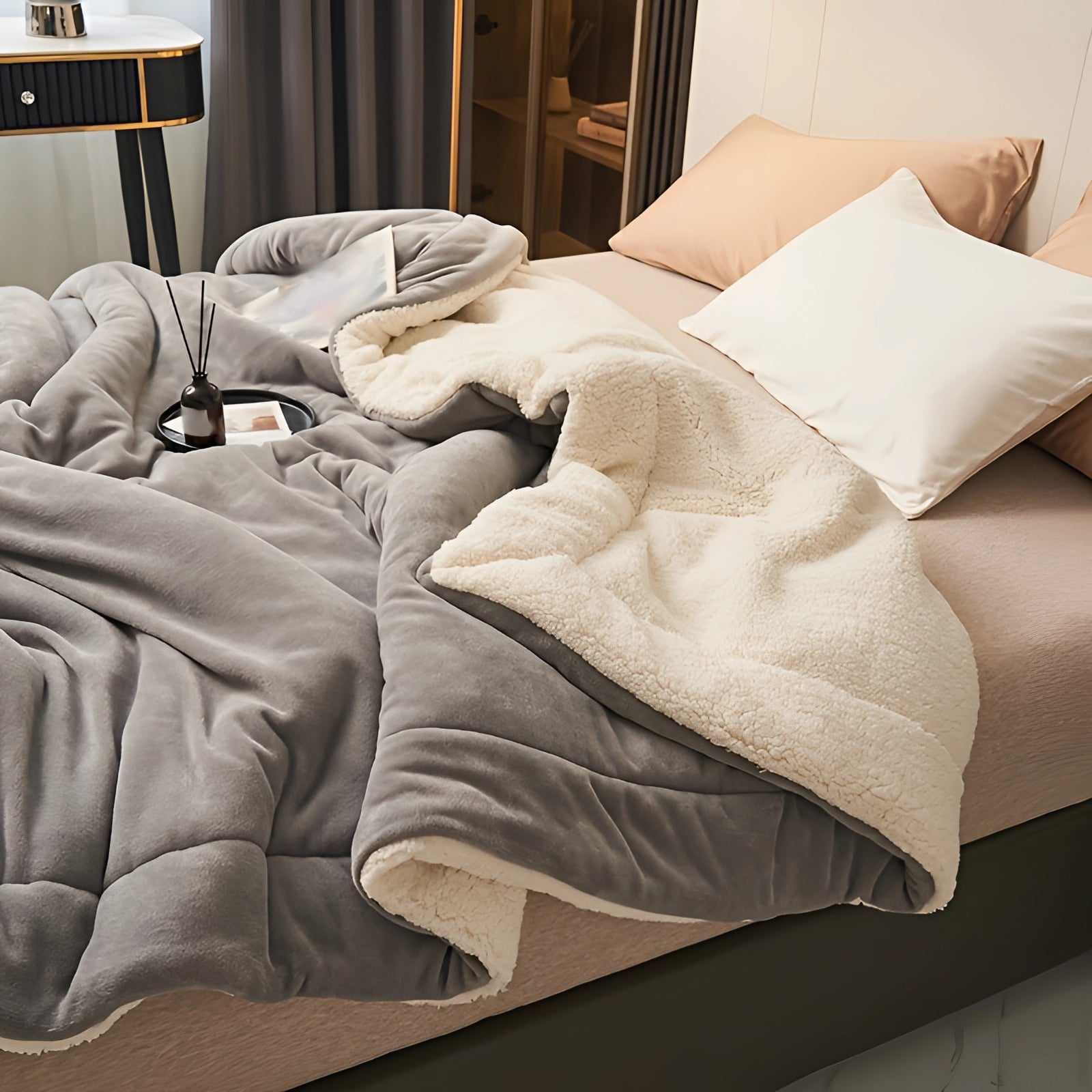 Luxury grey faux fur weighted blanket draped over a couch in a stylish living room, accentuating comfort and warmth; accompanied by decorative pillows and a wooden floor, creating a cozy and inviting interior design.