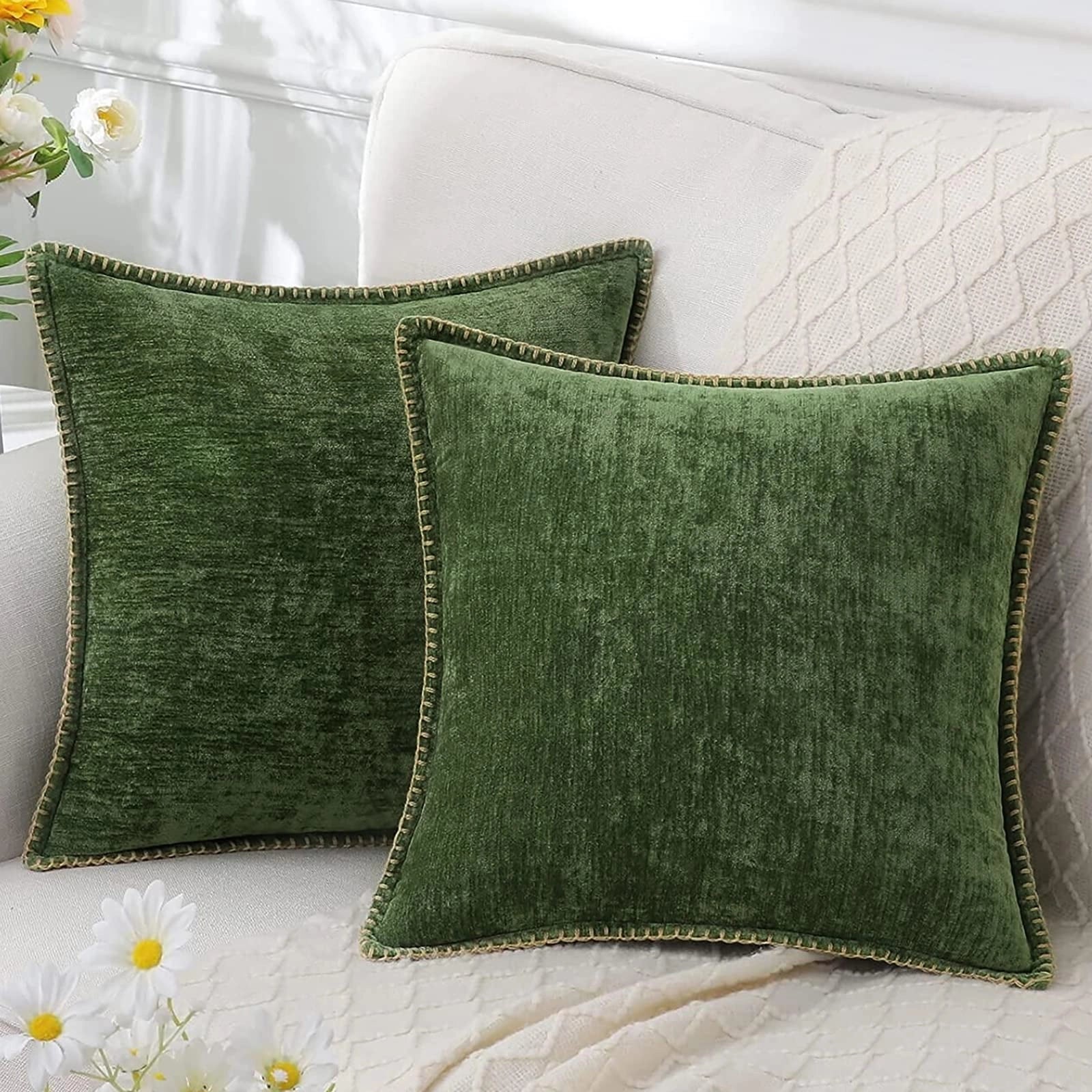 Luxurious green velvet throw pillows, set of four, featuring elegant soft decor with a subtle pattern, displayed on a wooden surface.