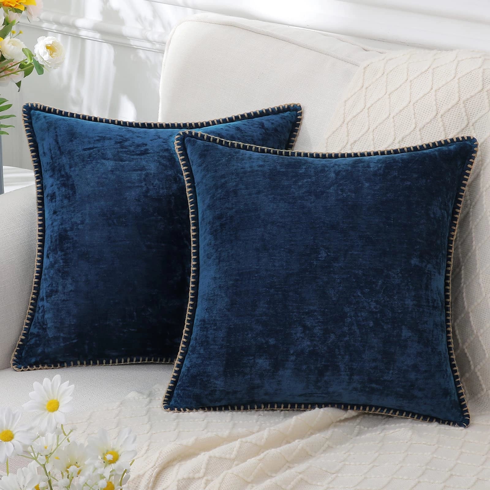 Dark blue velvet throw pillows in a set of four, featuring a soft and elegant design, displayed with a stylish azure and denim pattern.