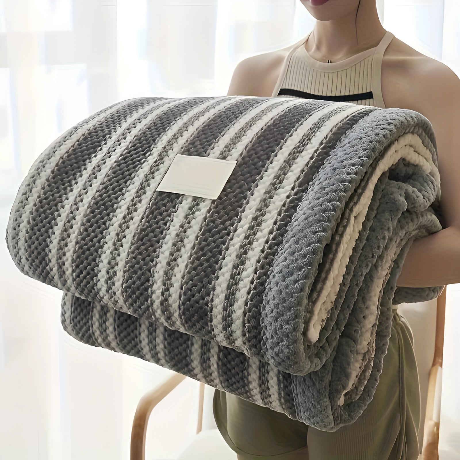 Luxury grey and white checkered fleece blanket draped over a surface, showcasing its plush texture and cozy design, ideal for warmth and comfort.