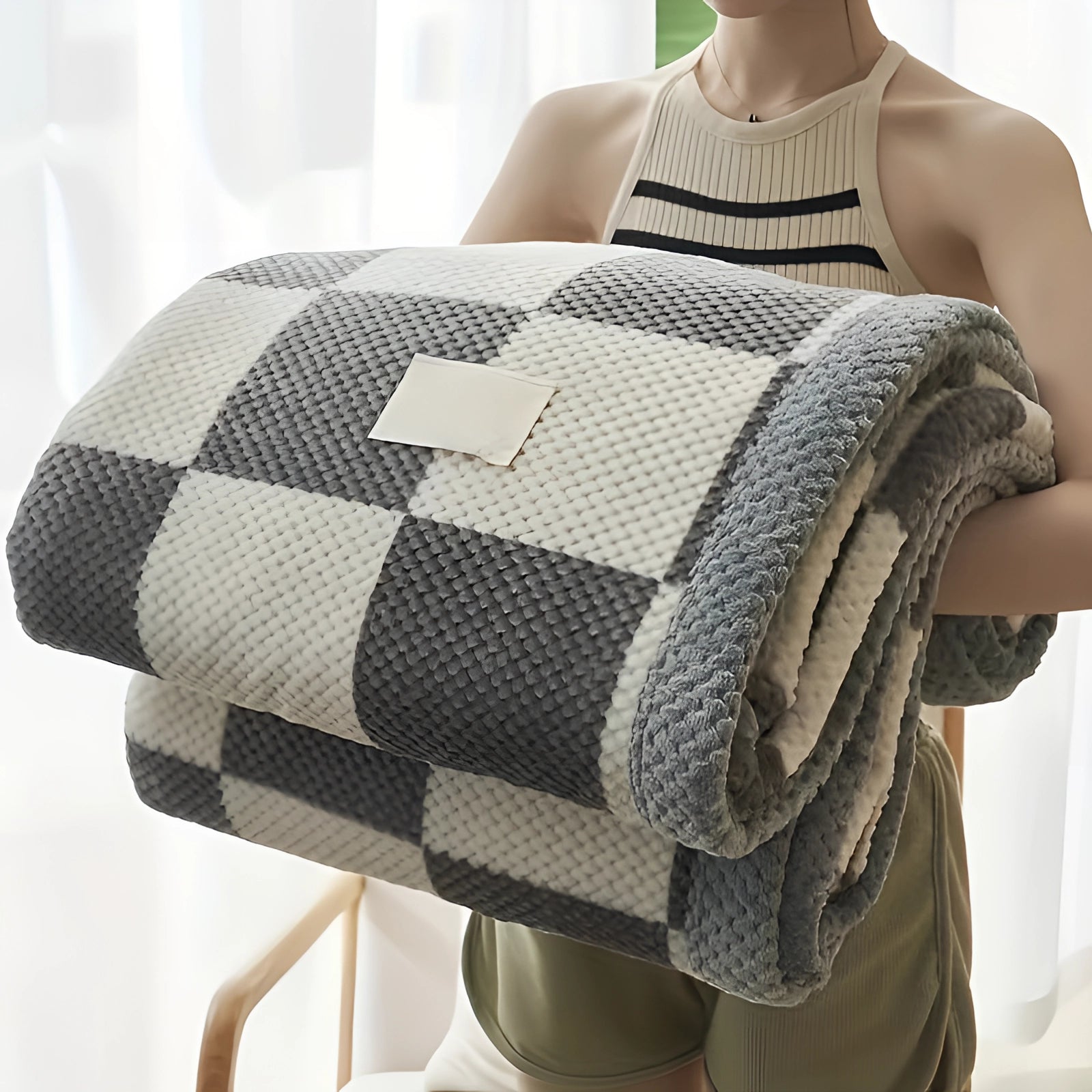 Luxury grey and white checkered fleece blanket draped over a surface, showcasing its soft and cozy plush texture. The blanket measures 200 x 230 cm, highlighting its generous size and stylish design for added comfort.