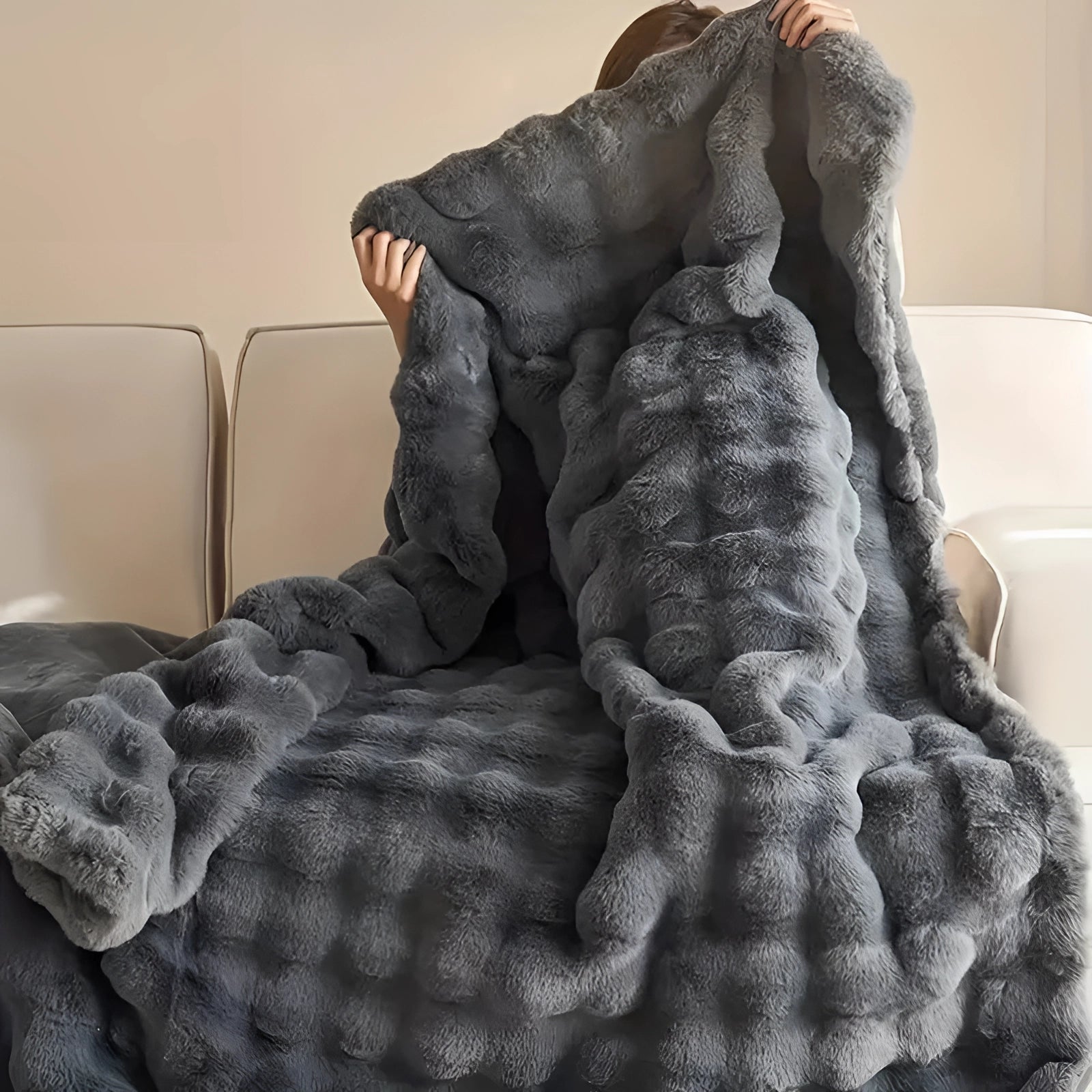 Luxurious chunky knit weighted blanket in a cozy grey color, elegantly draped over a wooden piece of furniture, with the texture showcasing an intricate pattern, creating a comfortable and inviting atmosphere.